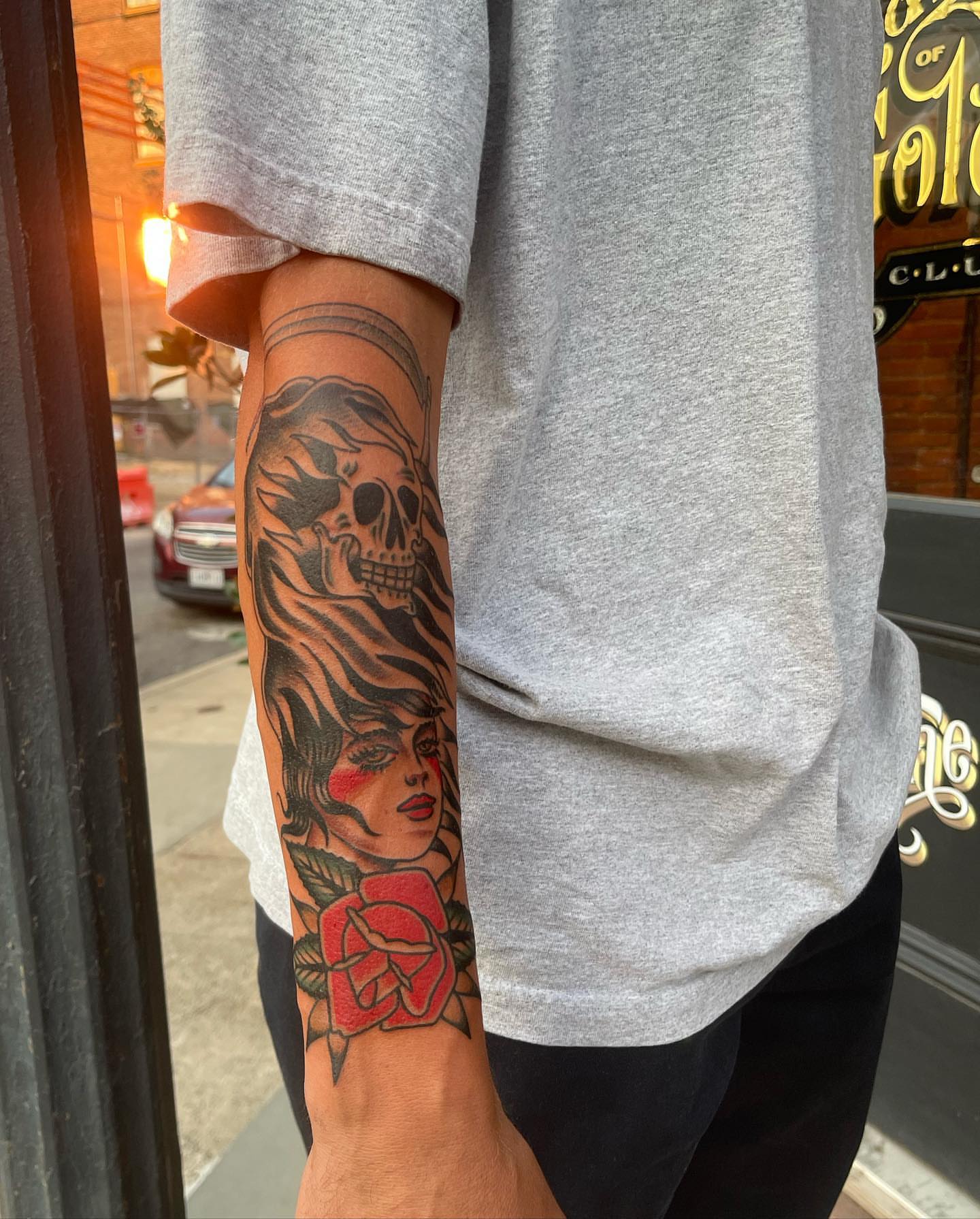 Woman with skull and rose American traditional tattoo on the forearm by Jeff Miller philly traditional tattoo