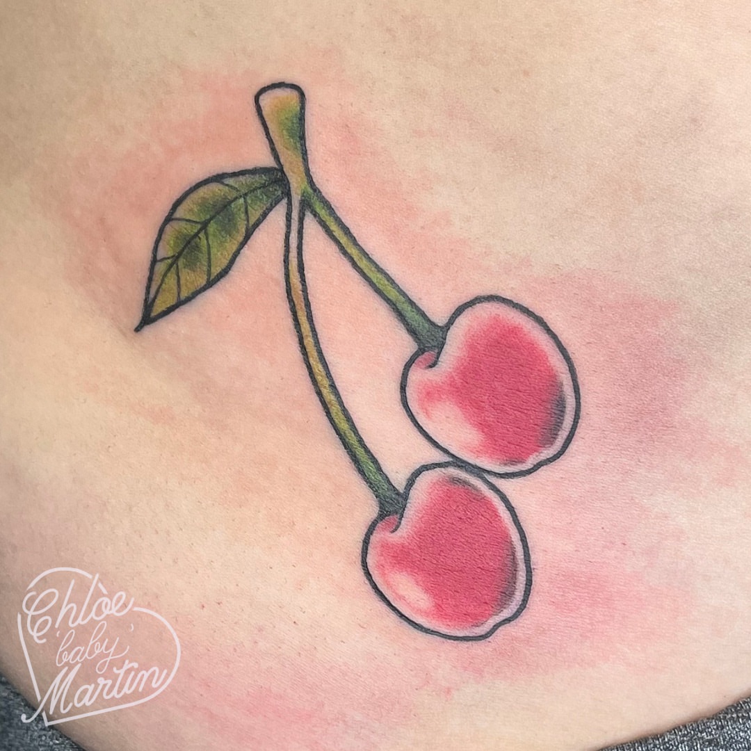 Cherries watercolor tattoo on the torso by Chloe ‘baby’ Martin