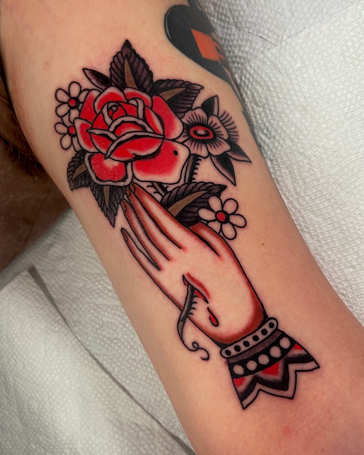 Praying hands with roses American traditional tattoo on the forearm by Chase Tucker