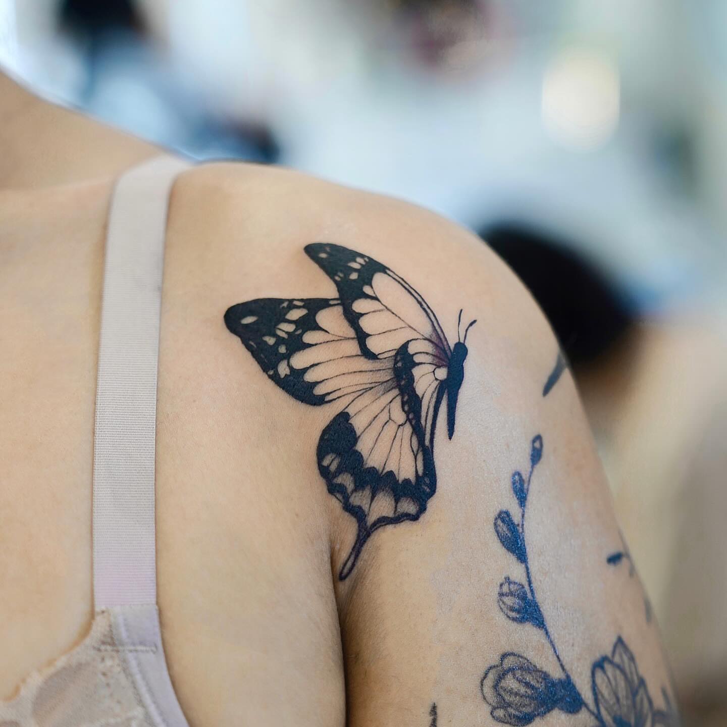 Butterfly black and grey tattoo on the shoulder by David H.