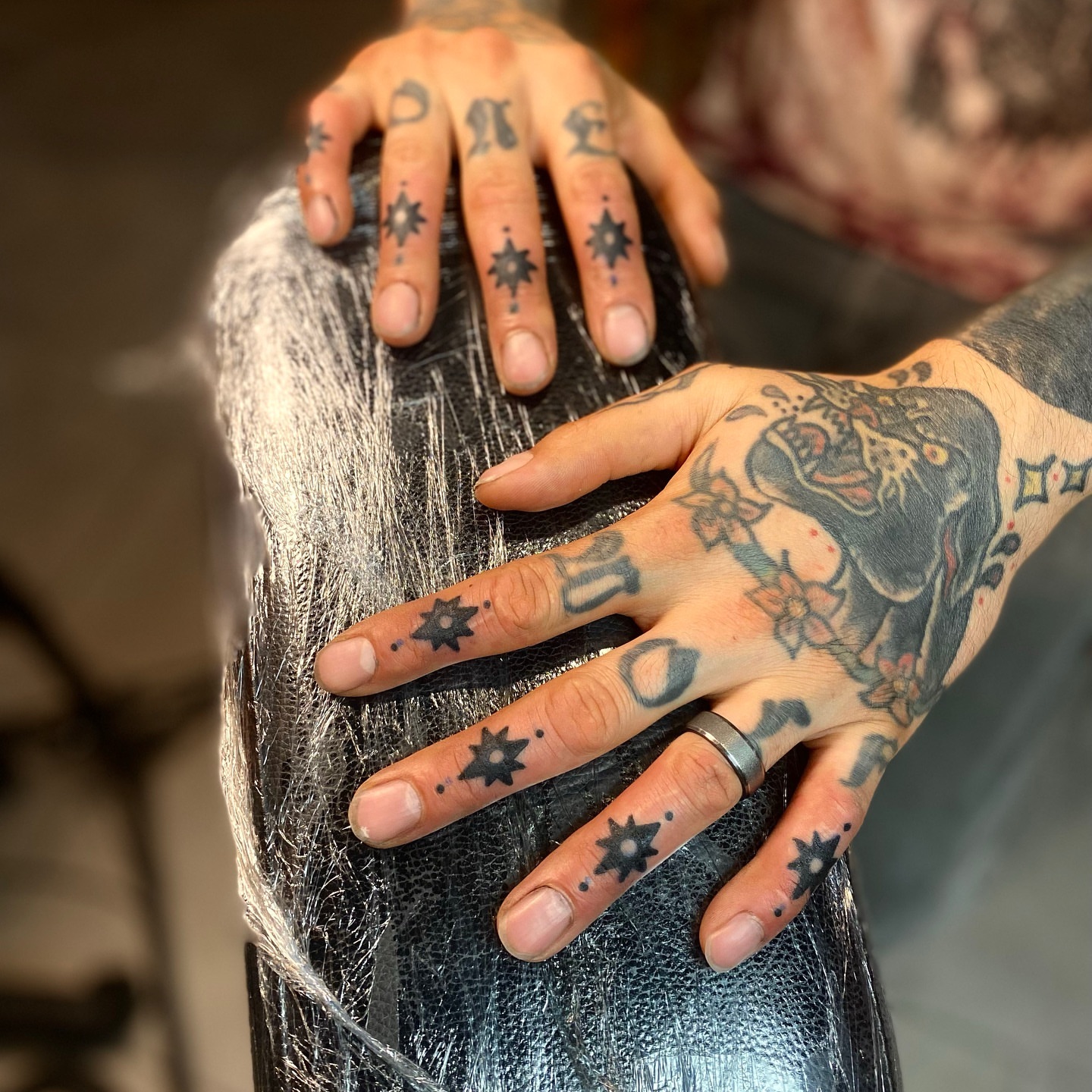 Skull and flowers American traditional tattoo on the hand by Myka King
