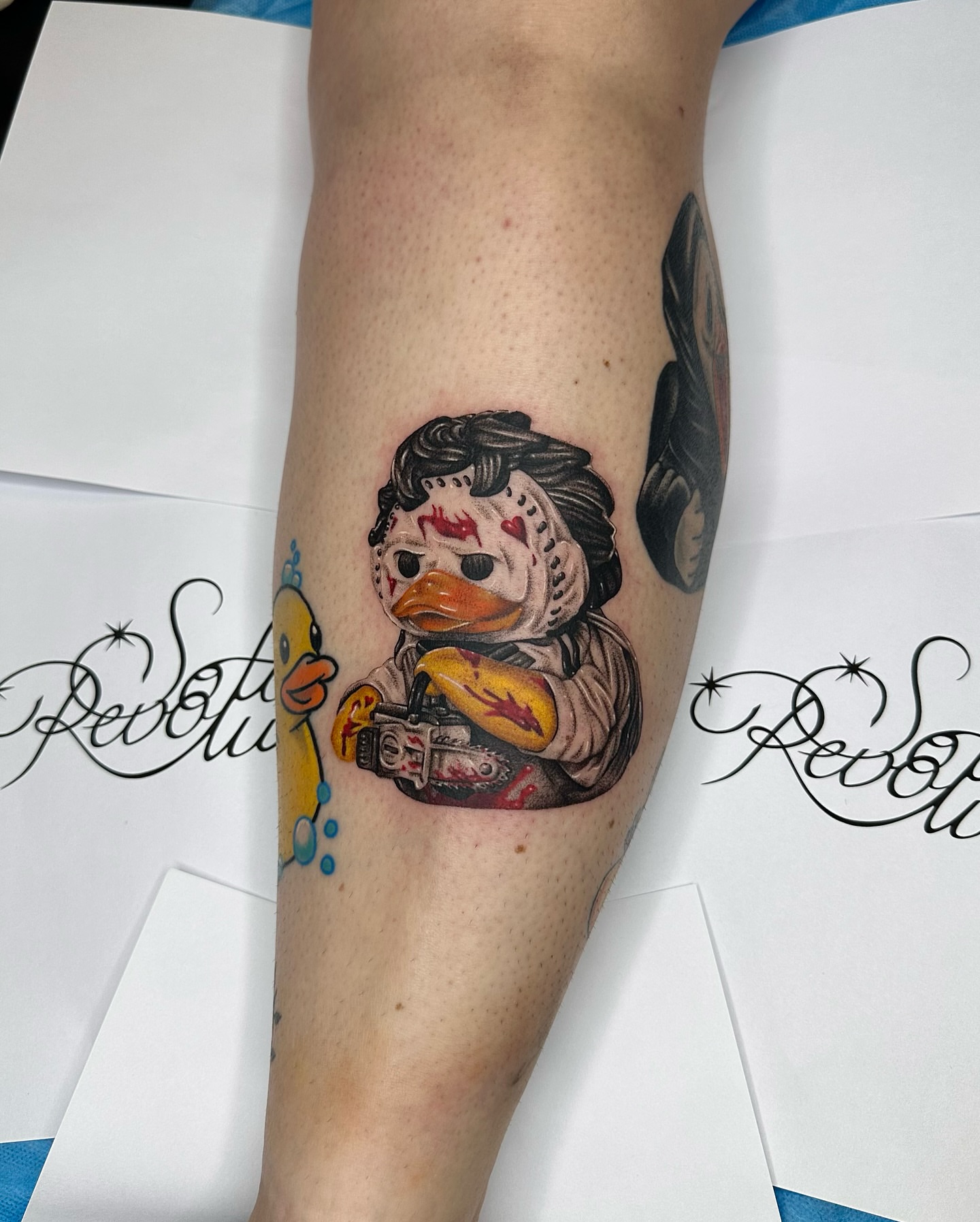 Duck with chainsaw American traditional tattoo on the forearm by Mystikal Blue Casares