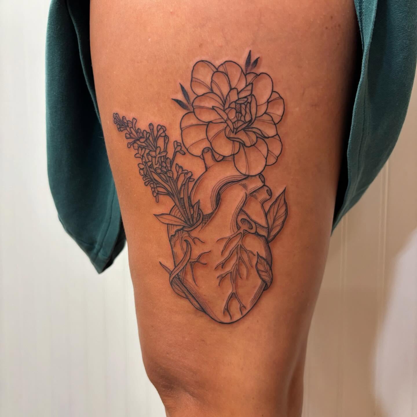 Anatomical heart with flowers black and grey tattoo on the thigh by Amber Lea, Kansas City, Kansas