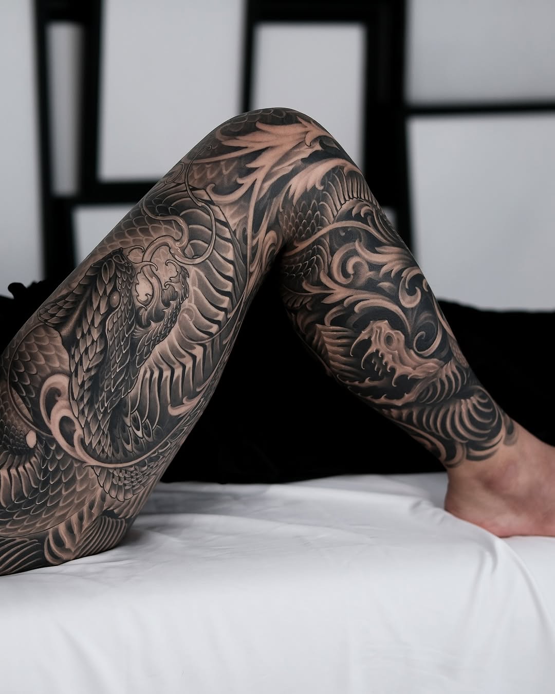Dragons and waves Japanese tattoo on the leg by Yujin Ju