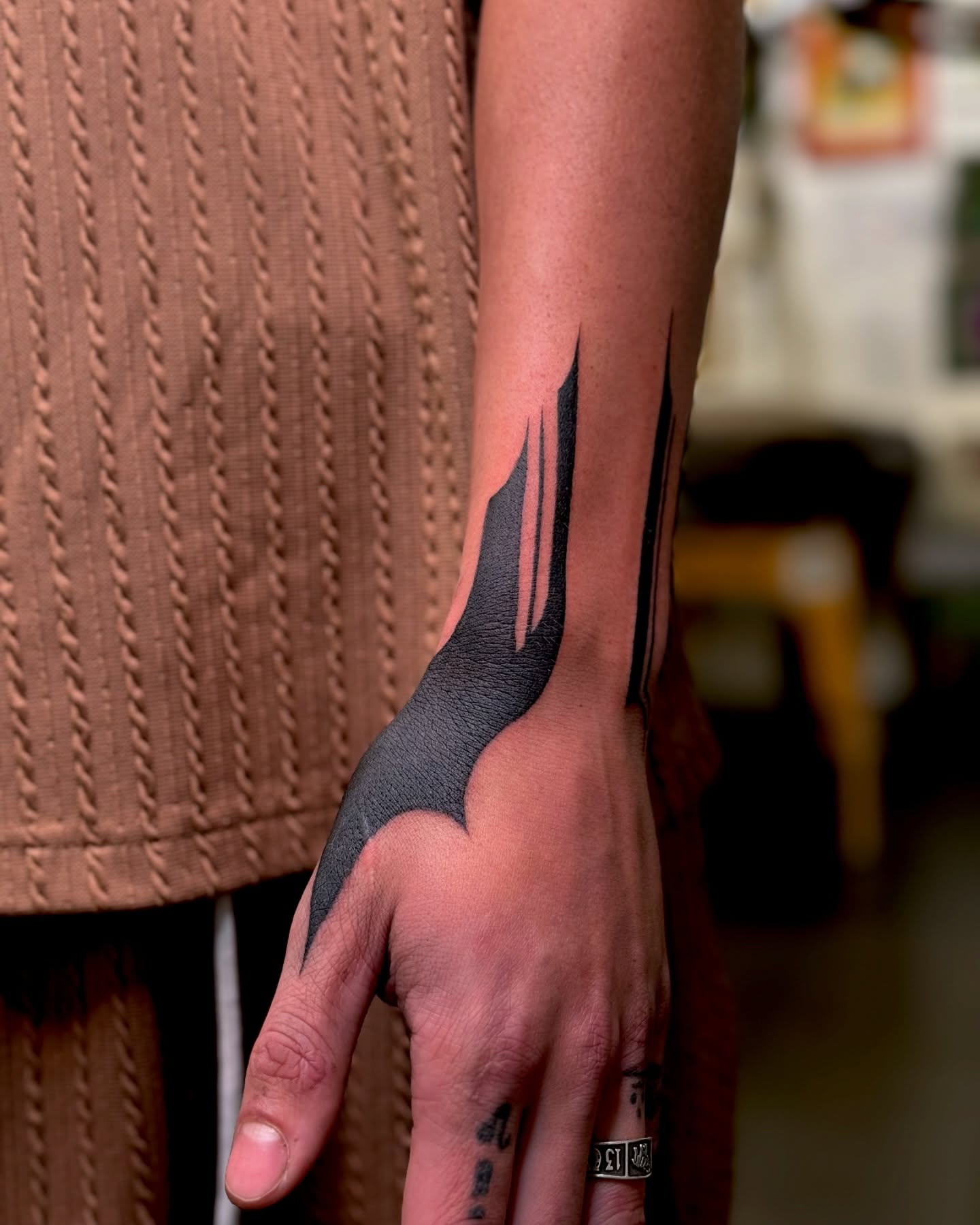 Batman logo black and grey tattoo on the forearm by Hailey K - Arizona Tattoo Artist, Miami, Florida
