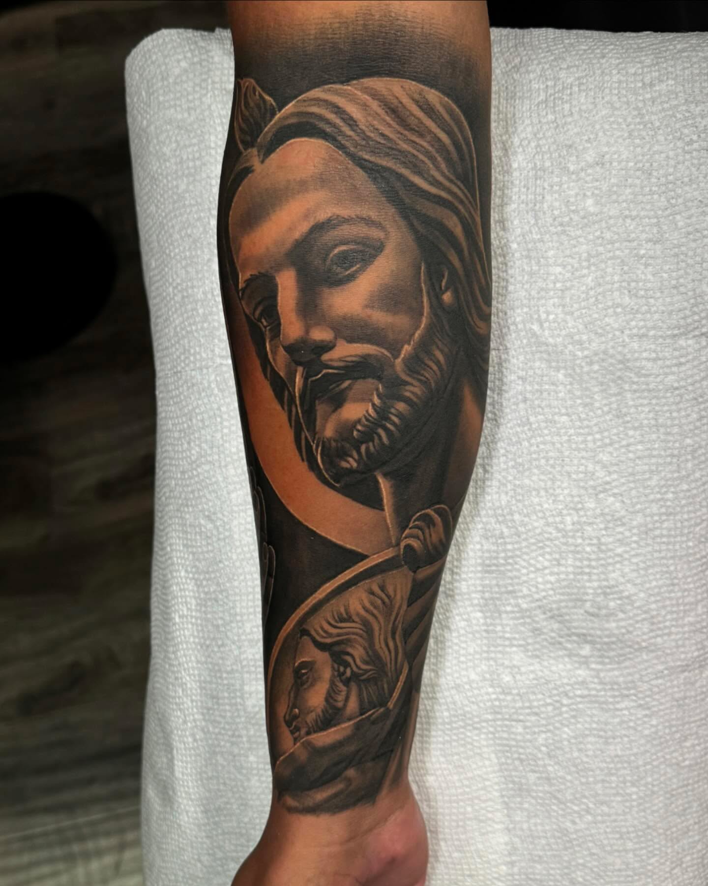 Religious figure realism tattoo on the forearm by Anthony Duran