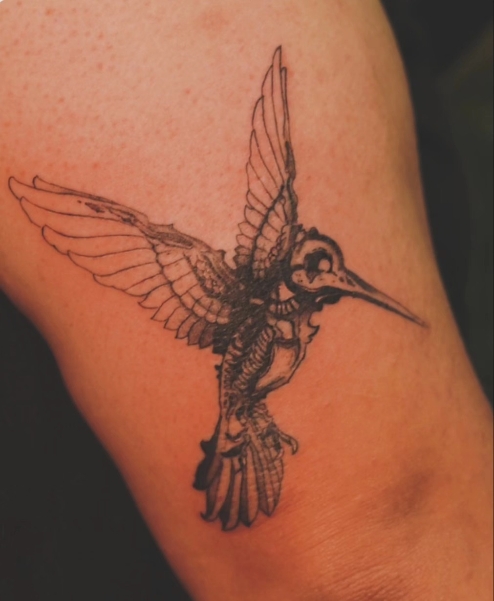 Hummingbird black and grey tattoo on the upper arm by Johnathan Nguyen