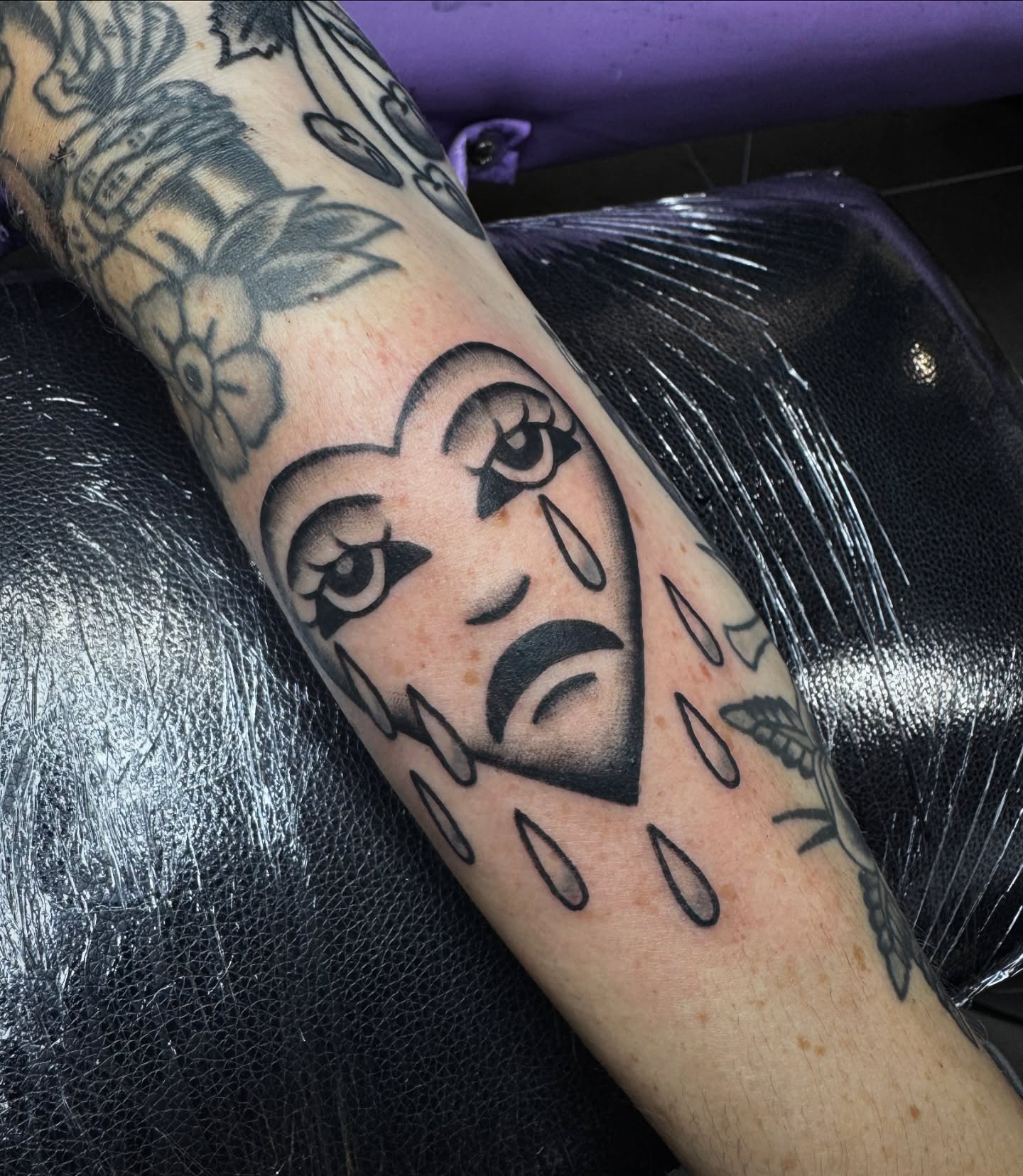 Woman's face black and grey tattoo on the forearm by Mazie