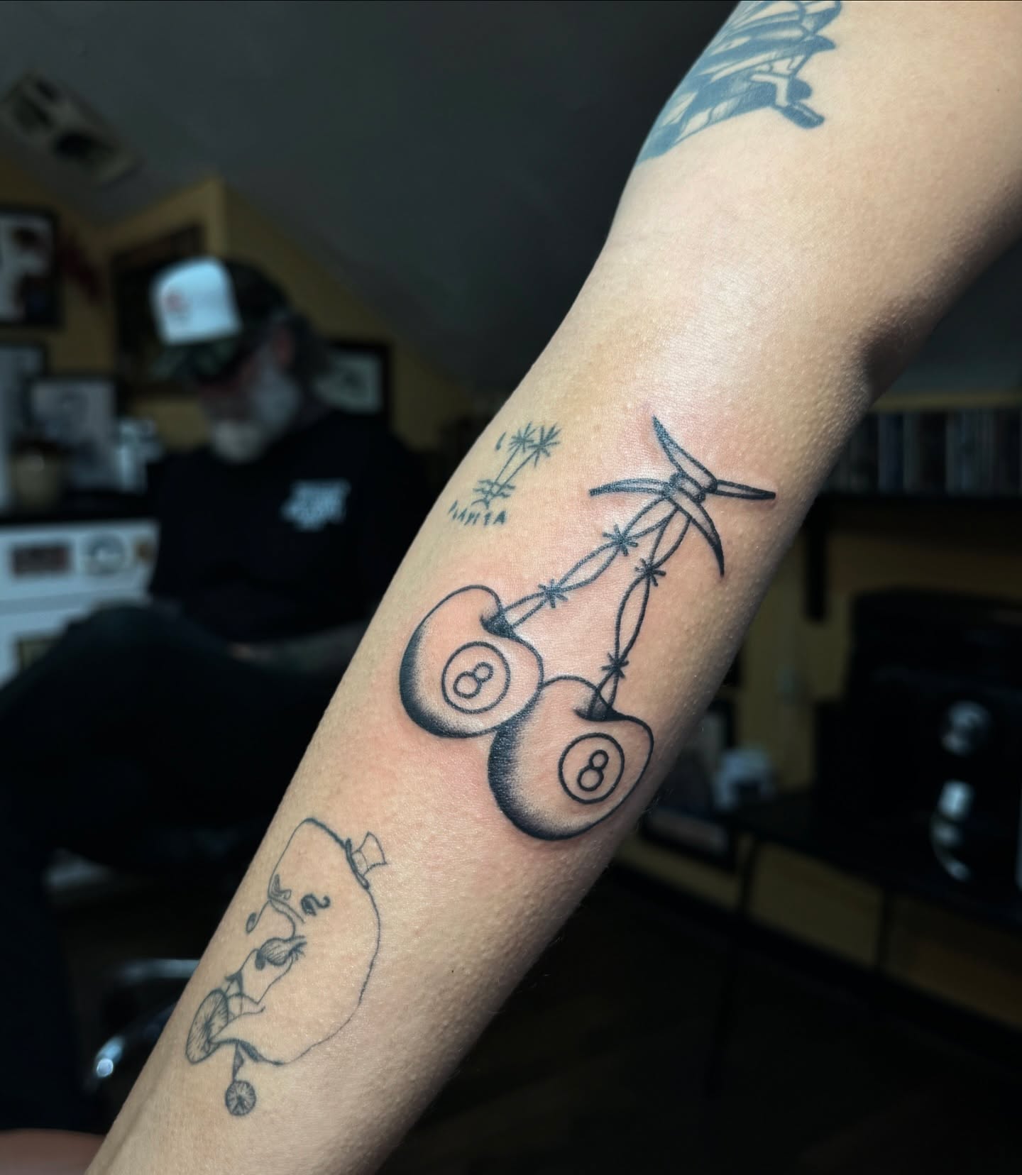 Billiard balls black and grey tattoo on the forearm by Mazie