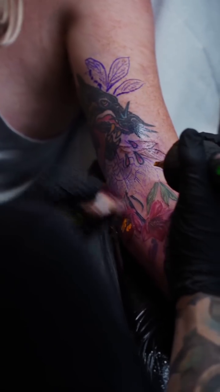 Floral arrangement with a bird neo-traditional tattoo by Colorful Tattoos by Cody Dean