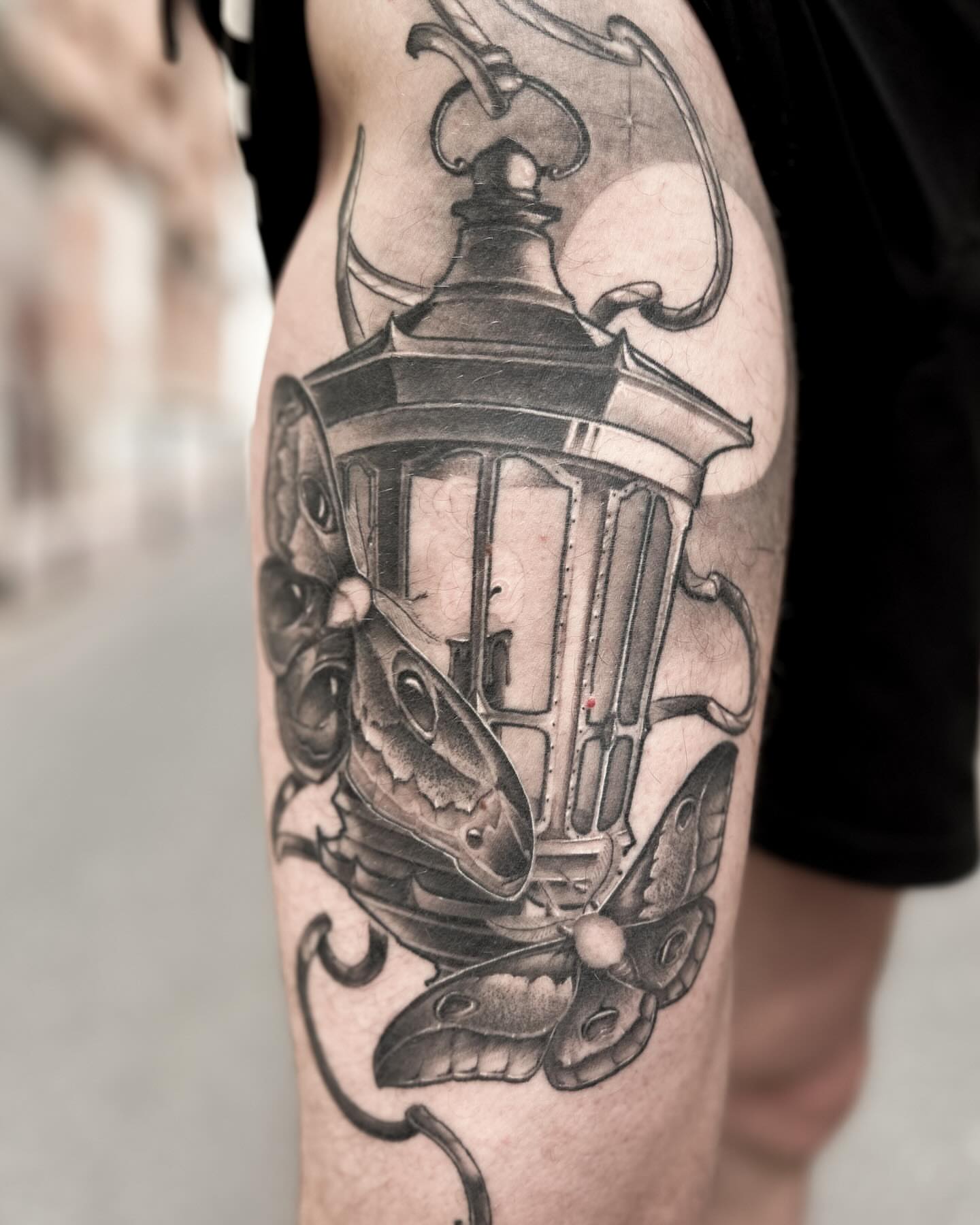 Street lamp with butterflies realism tattoo on the thigh by Eltche Art Tattoo