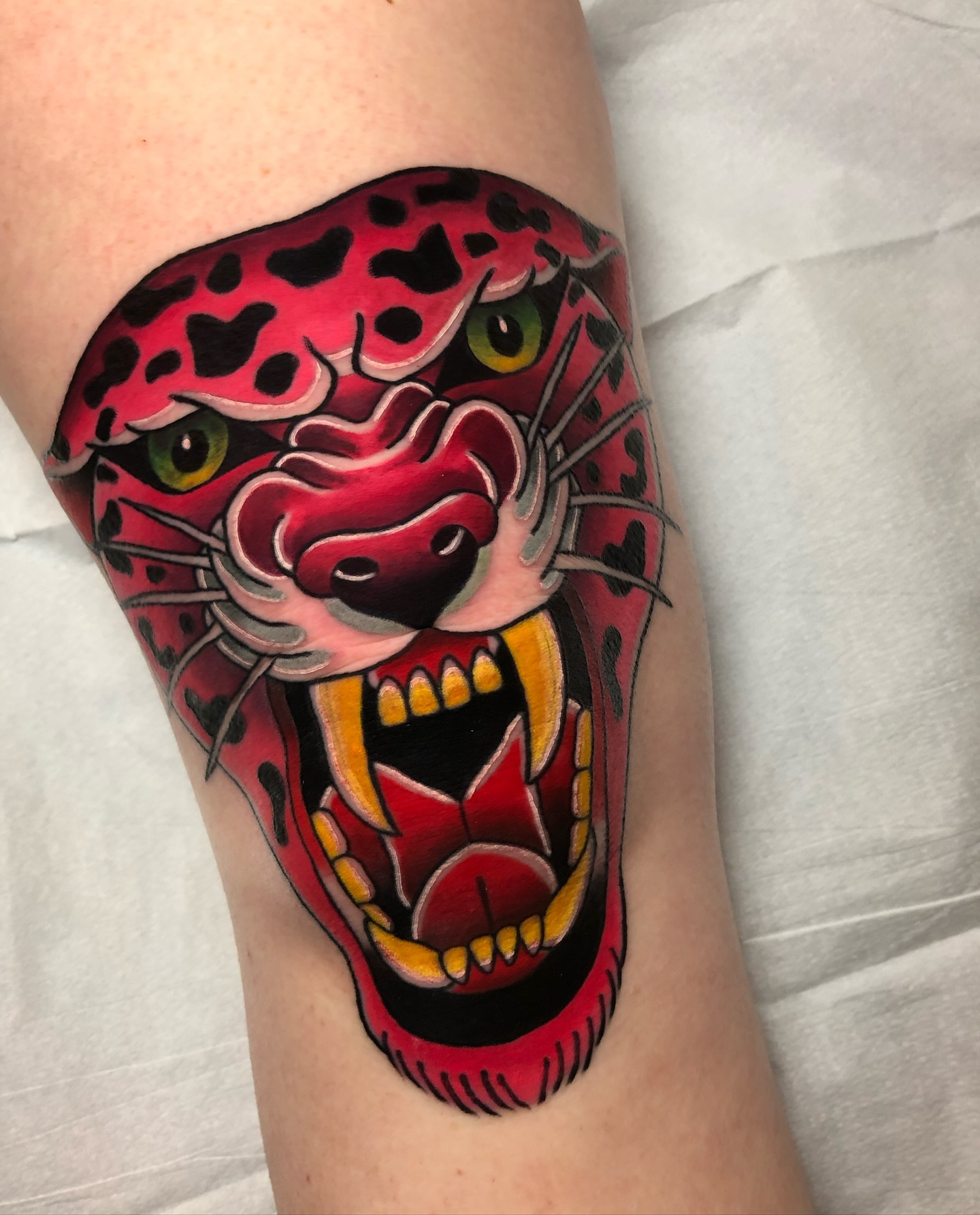 Roaring jaguar American traditional tattoo on the thigh by Melissa Brown
