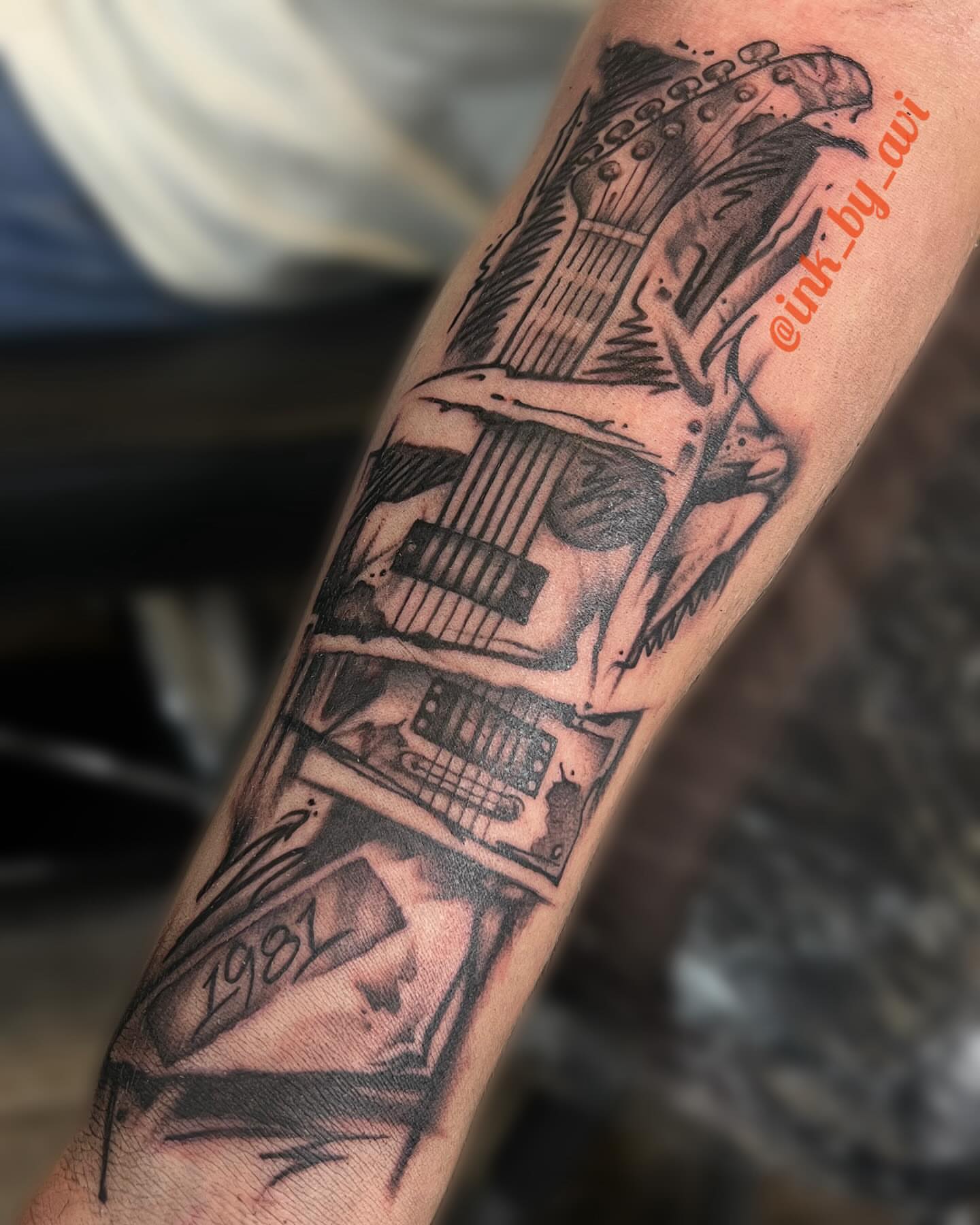Guitar black and grey tattoo on the forearm by Avi, Cleveland, Ohio