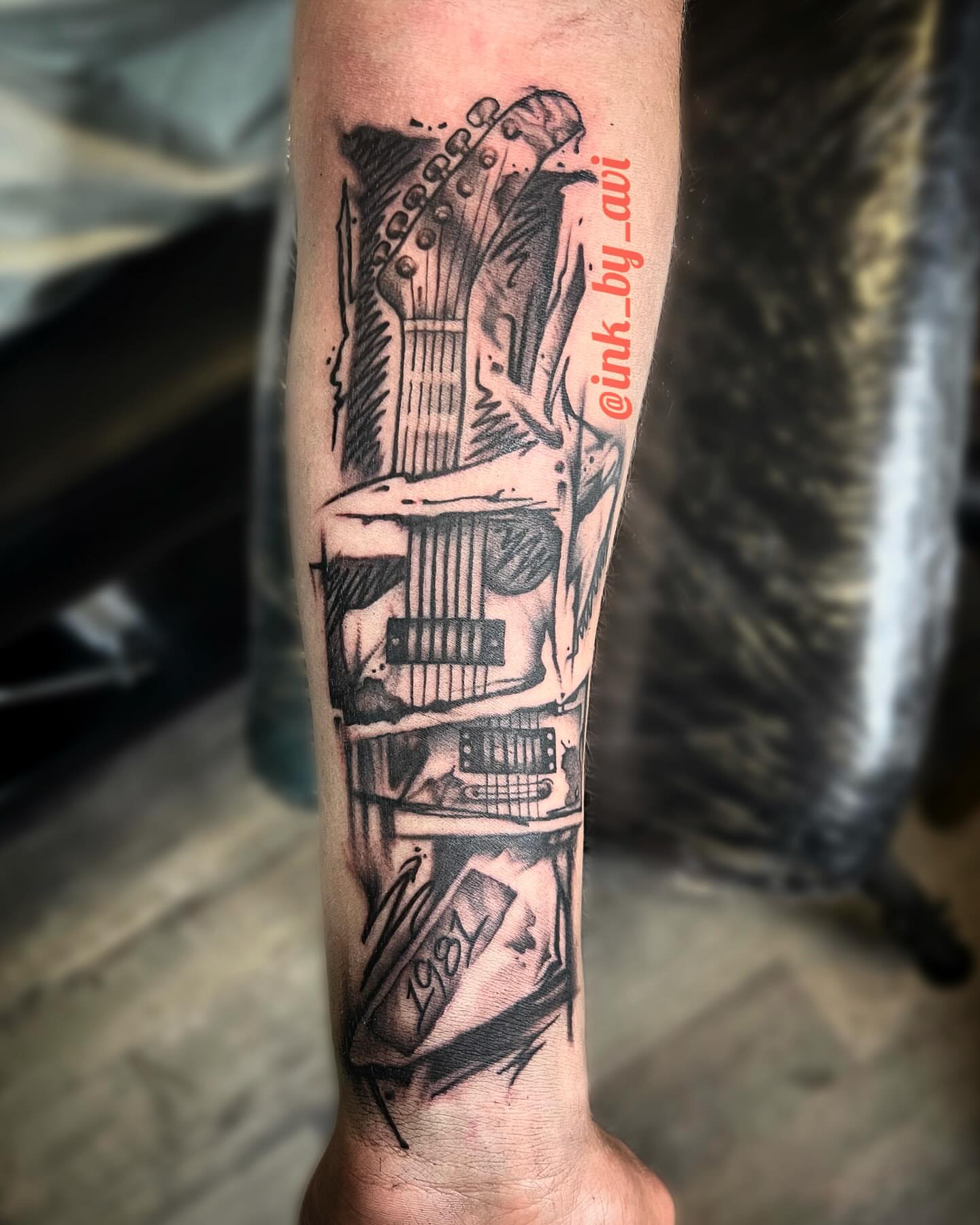 Electric guitar black and grey tattoo on the forearm by Avi, Cleveland, Ohio