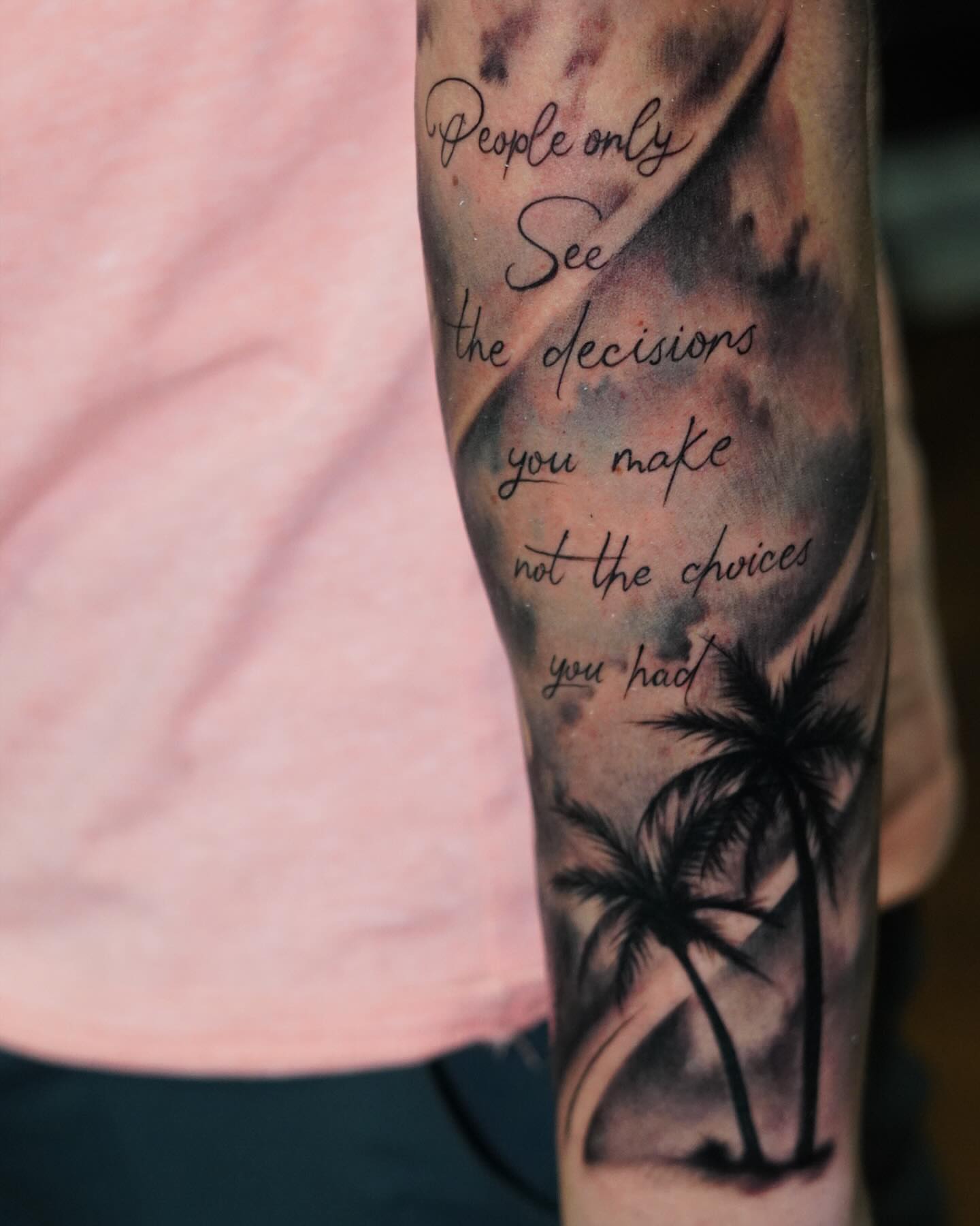 Palm trees and quote black and grey tattoo on the forearm by Angel Gonzalez