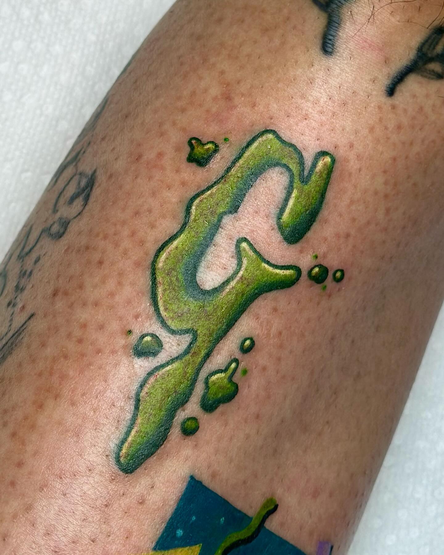 Liquid letter new school tattoo on the forearm by Katie Kelley