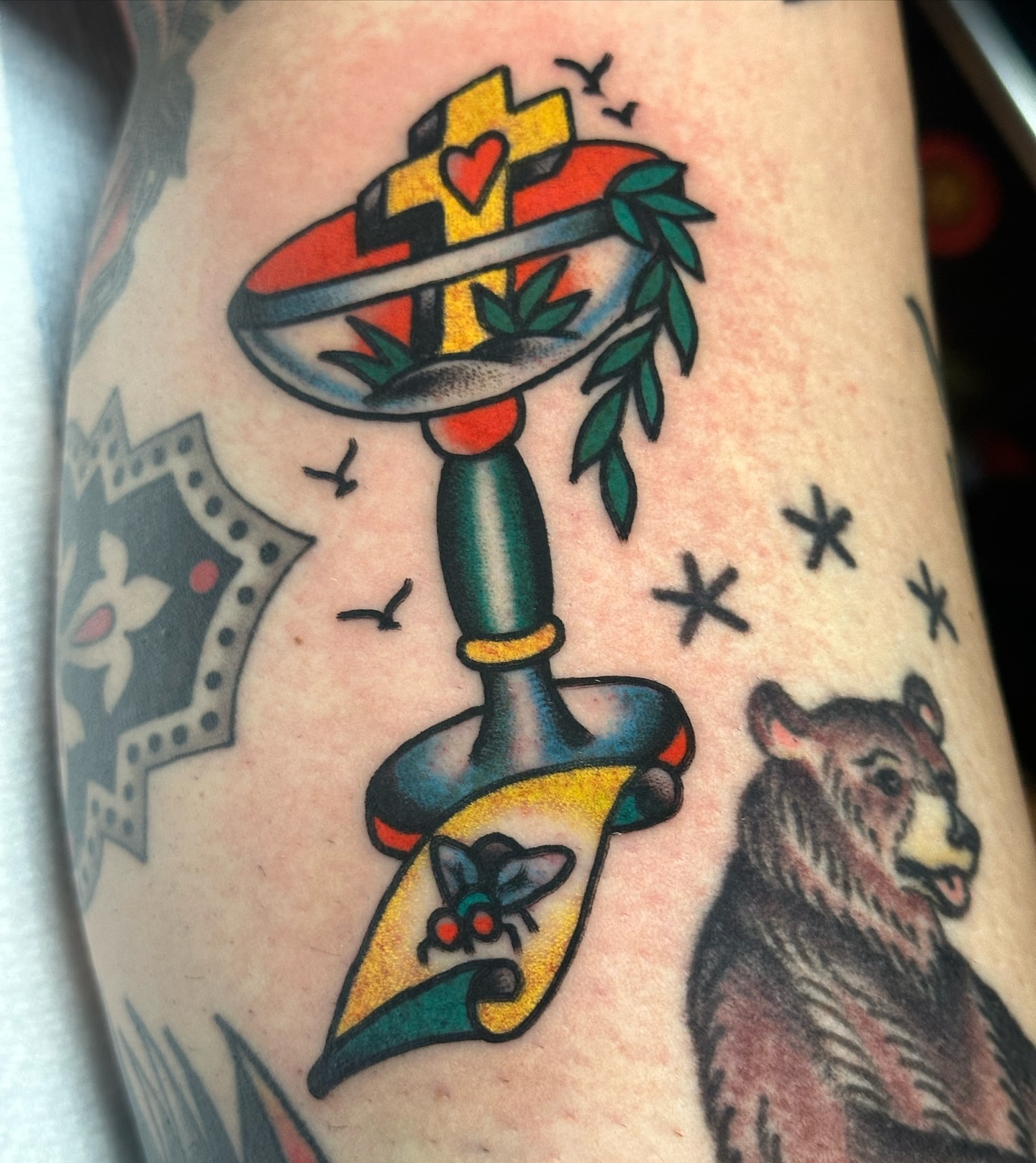Sword and cross American traditional tattoo on the forearm by Britney Goodman
