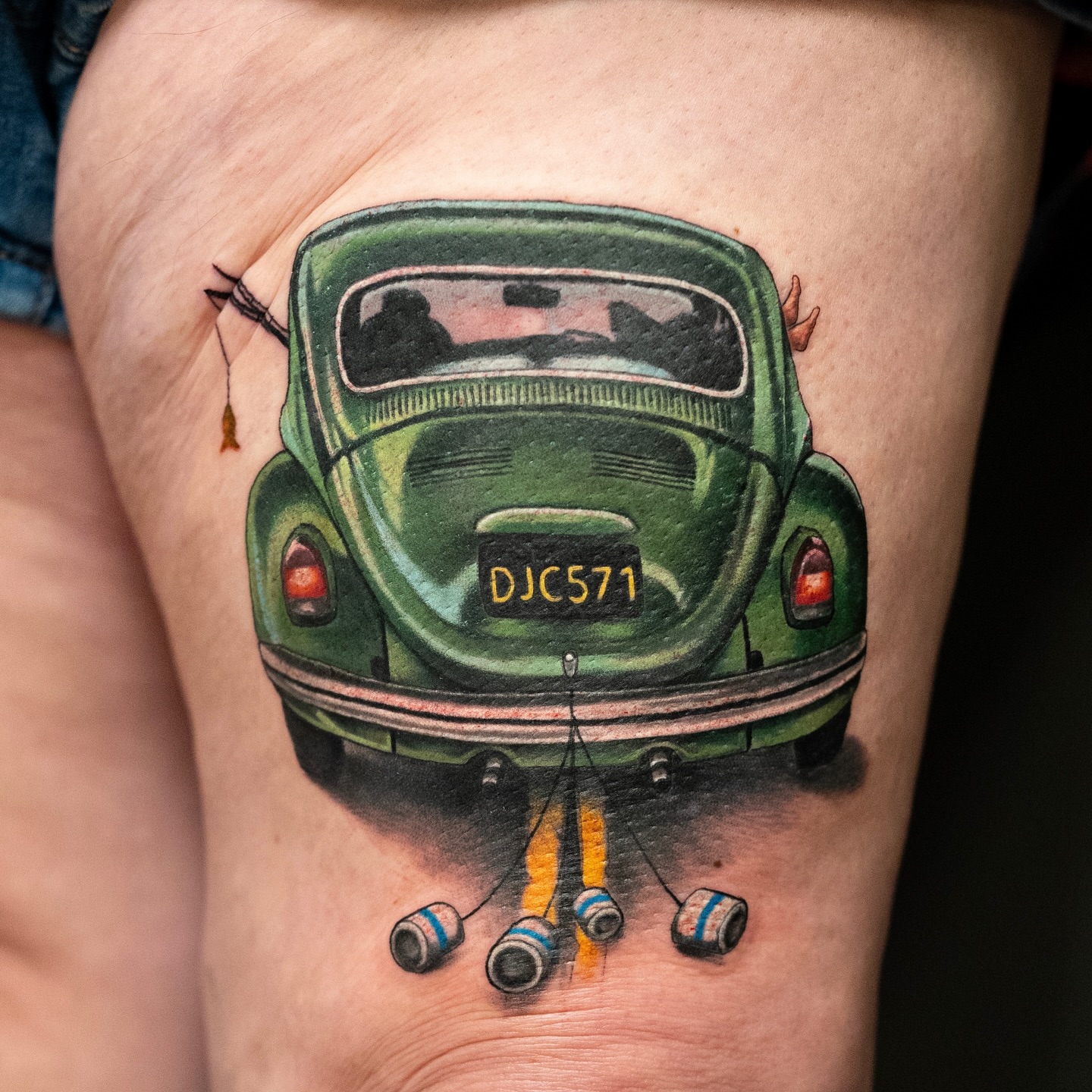 Green beetle car realism tattoo on the thigh by Alonzo Villa Tattoo
