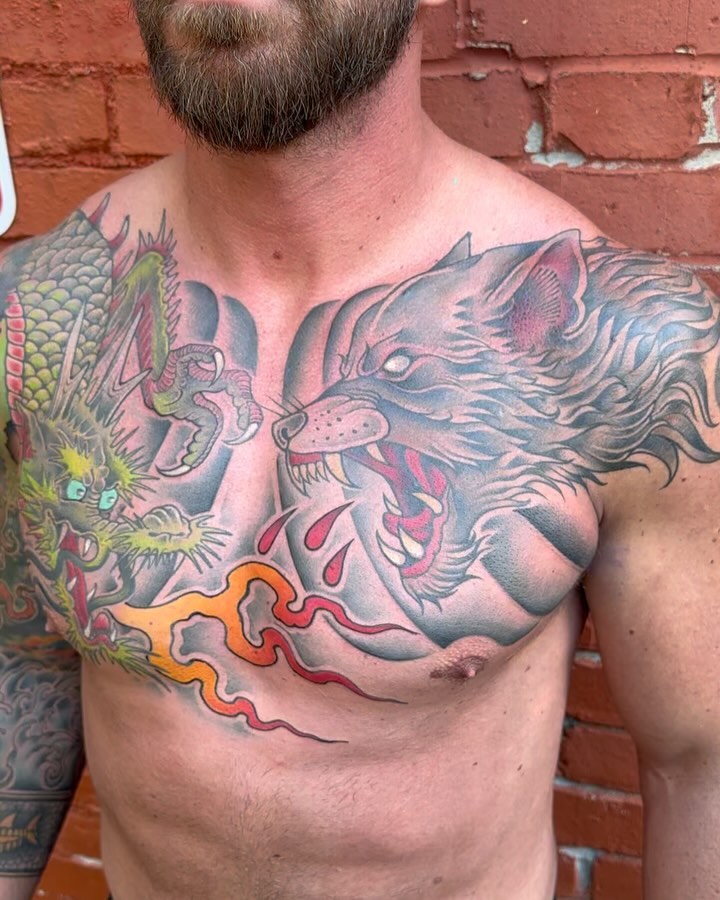 Wolf and dragon American traditional tattoo on the chest by Mark Boller
