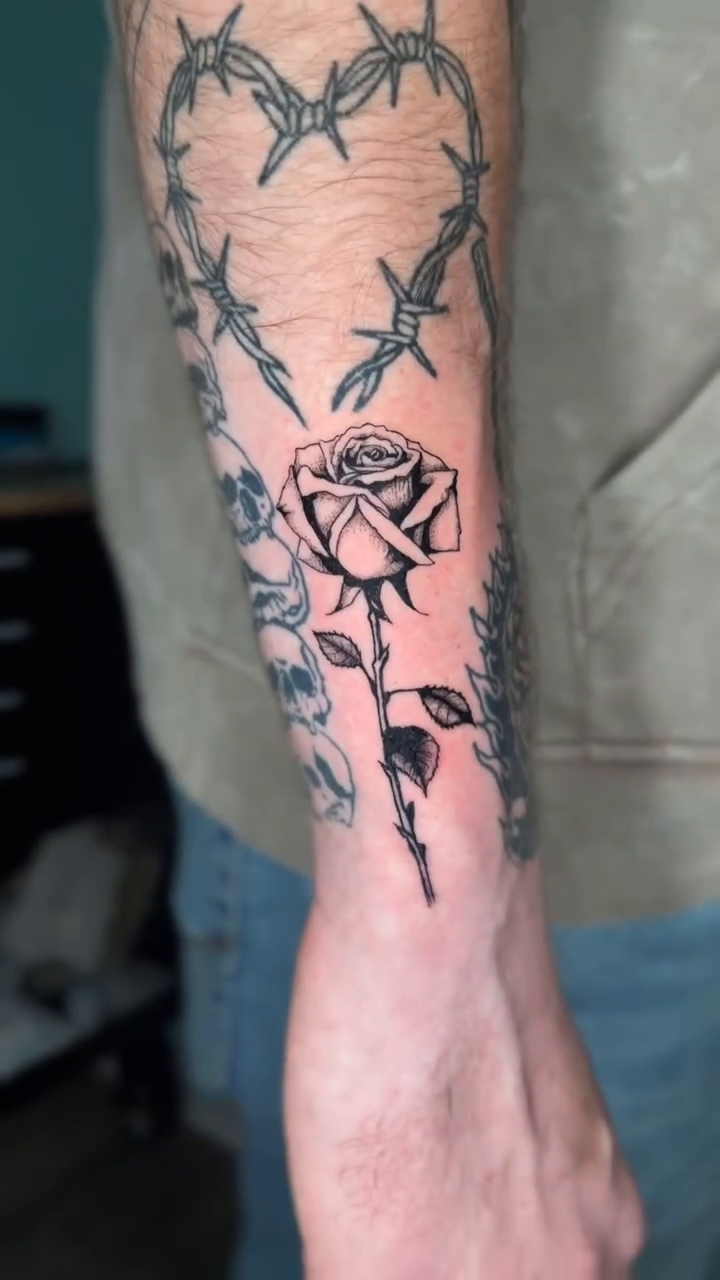 Heart with rose and thorns fine line tattoo by Gage Cottrell