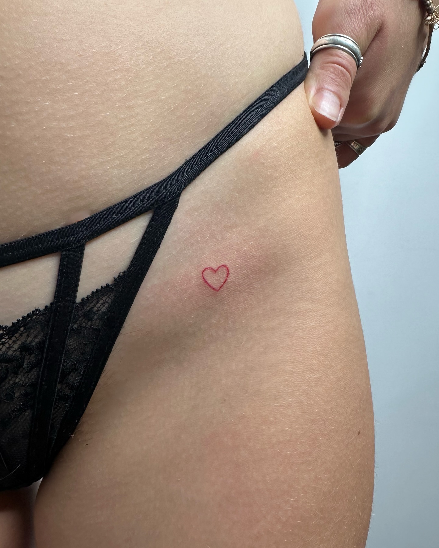 Heart minimalist tattoo on the thigh by ˖⁺‧₊˚Suzie handpoke˚₊‧⁺˖