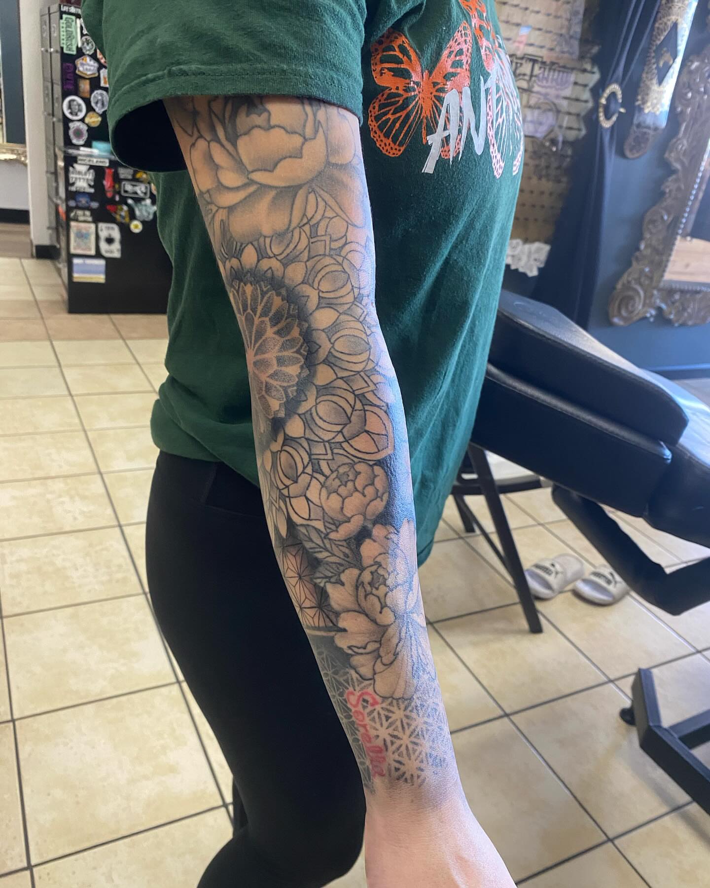 Floral bouquet geometric tattoo on the forearm by Nicholas Jones