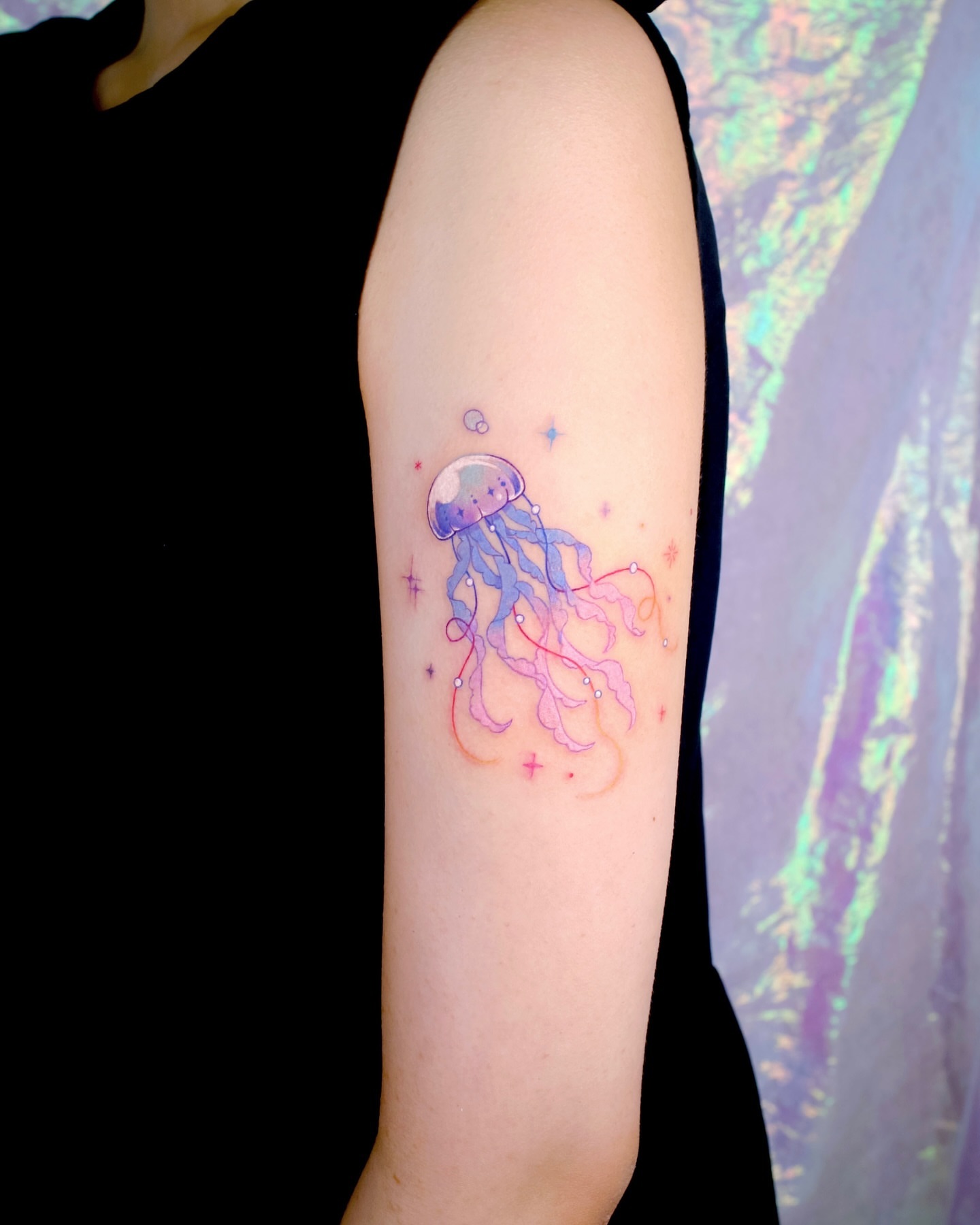 Jellyfish watercolor tattoo on the forearm by 밍꽈 타투