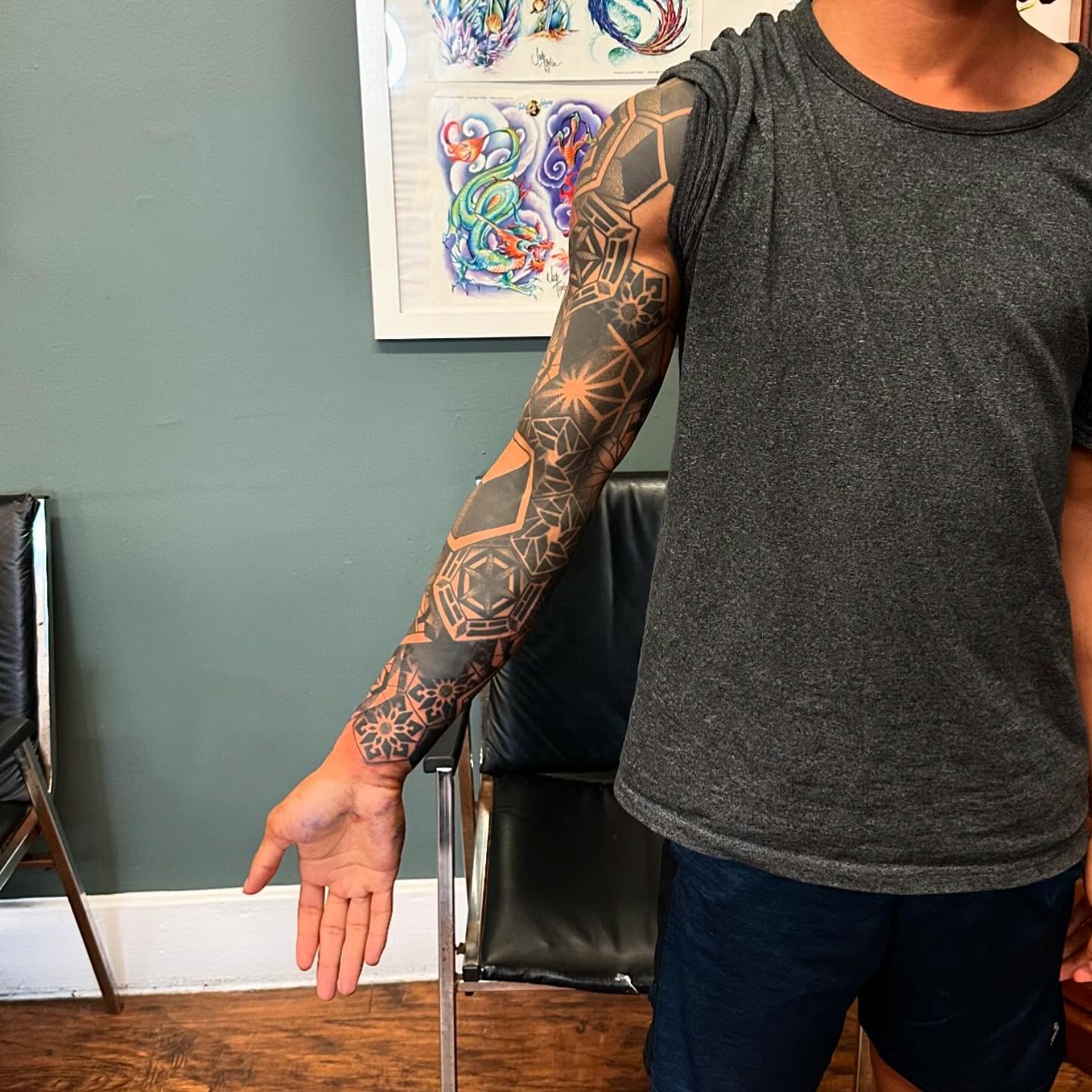 Geometric pattern geometric tattoo on the upper arm by Jackie