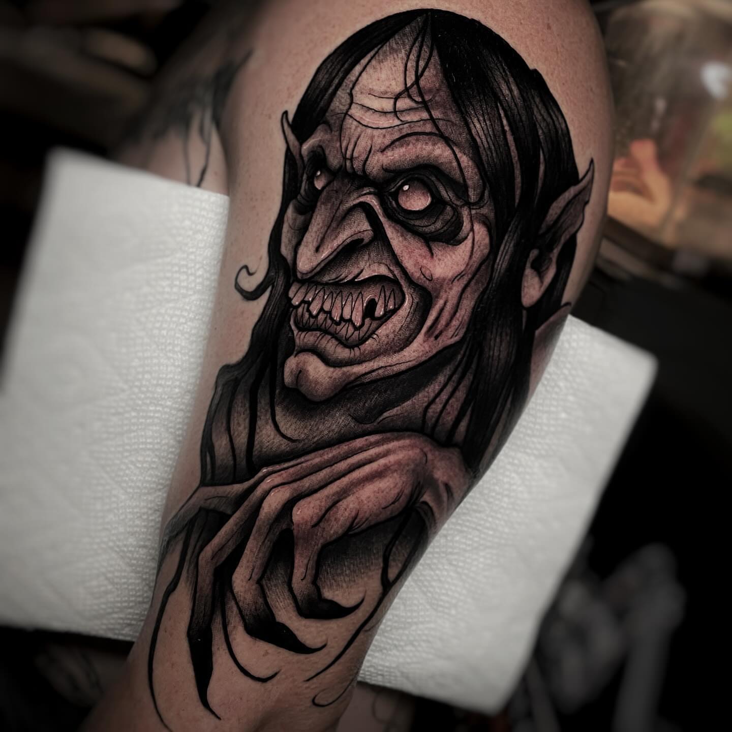 Demon face dark realism tattoo on the forearm by Ick Abrams