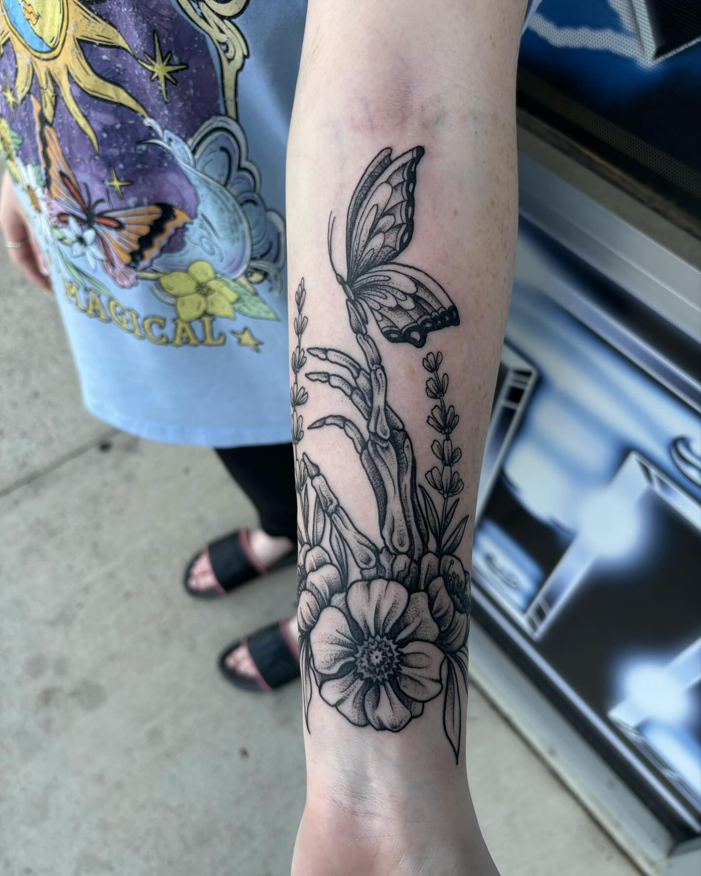 Butterfly and flowers black and grey tattoo on the forearm by Ares Rhodes