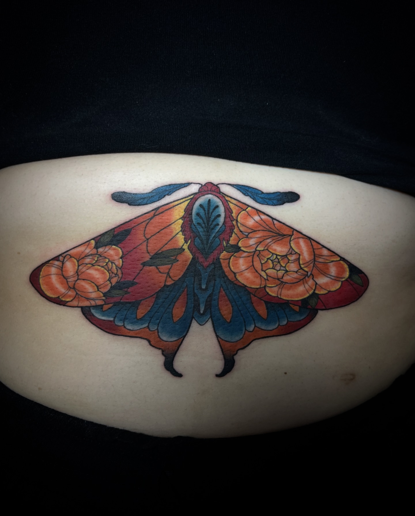 Moth with floral wings American traditional tattoo on the torso by Iraymi Beltran