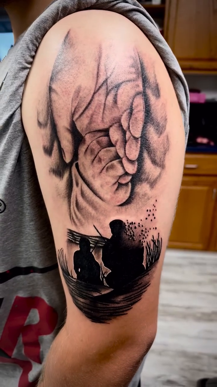 Hand holding silhouettes of people surrealism tattoo on the shoulder by Luis Cabrera, Cleveland, Ohio