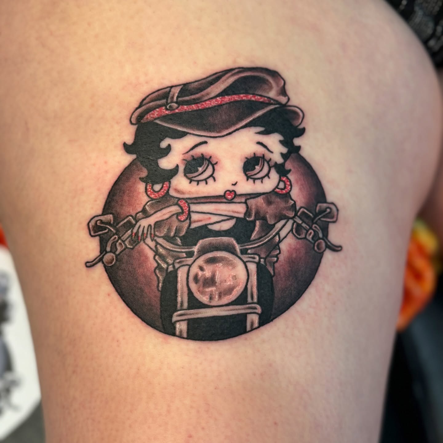 Betty Boop on motorcycle American traditional tattoo on the shoulder by Ashley Rose - Minnesota Tattoo Artist