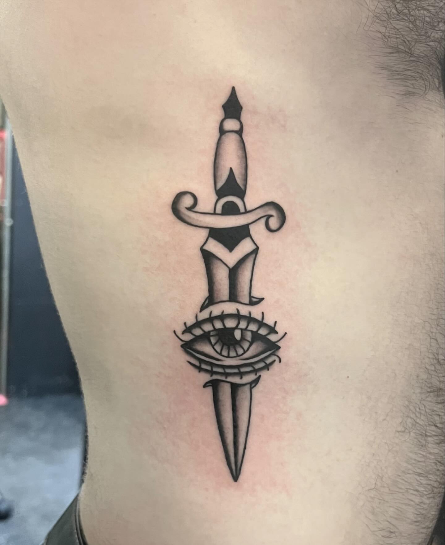 Eye and dagger black and grey tattoo on the ribs by Erika Donn, Portland, Oregon