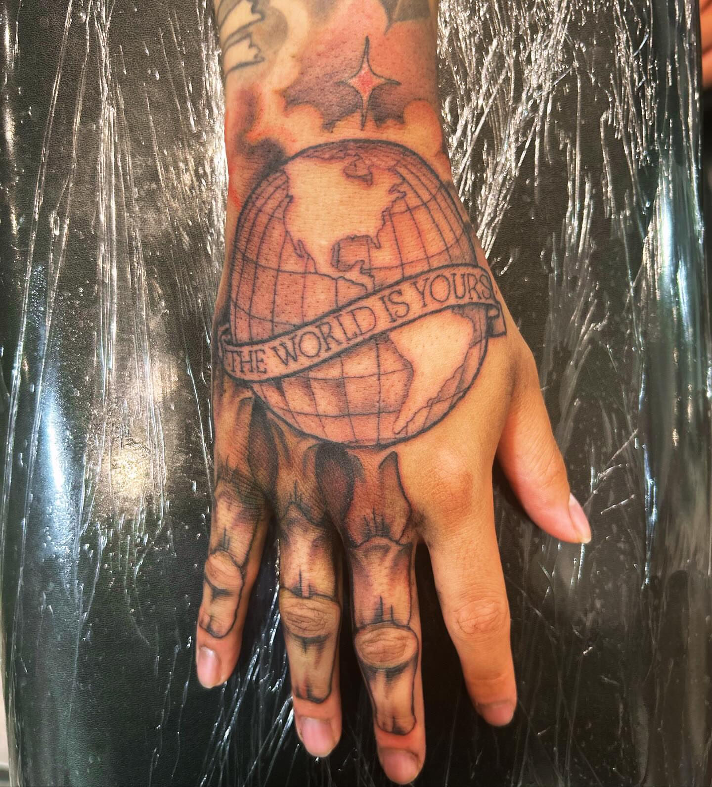 World globe black and grey tattoo on the hand by 🇬🇹