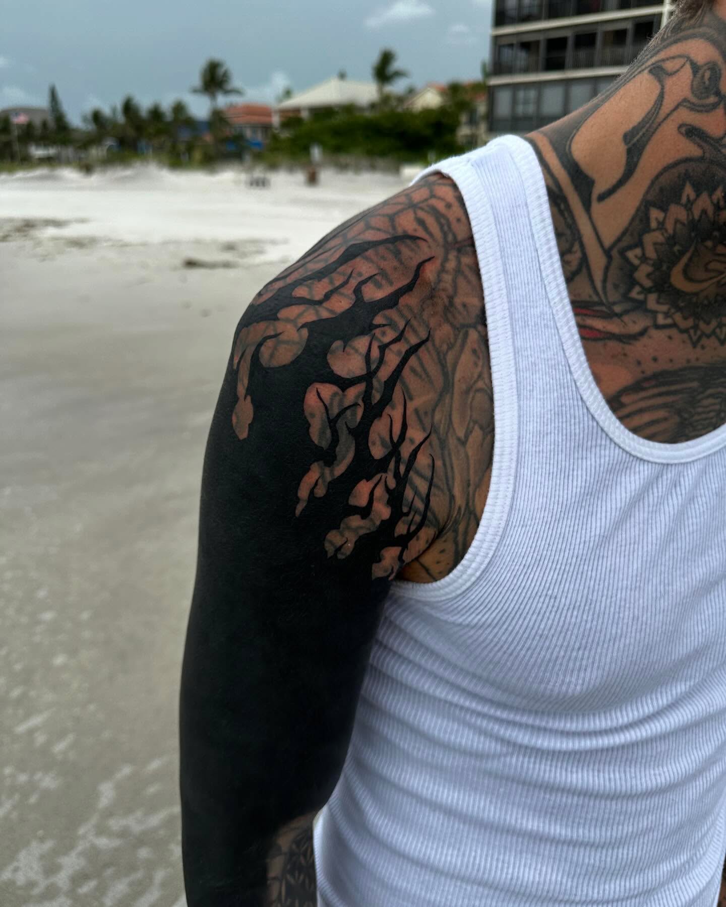 Floral vine black and grey tattoo on the upper arm by Ryan K Severe
