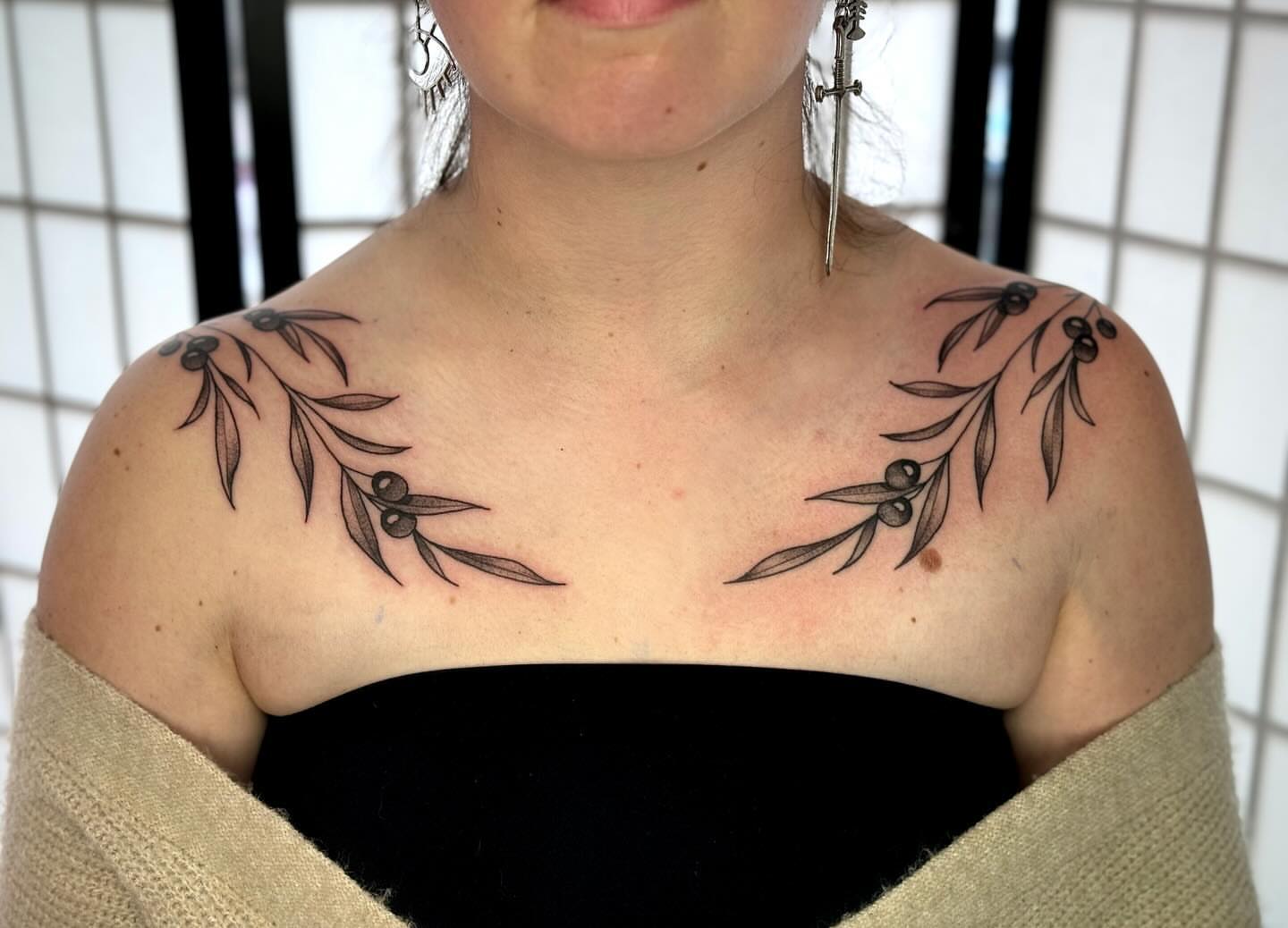 Olive branch black and grey tattoo on the shoulder by Lauren Peltz