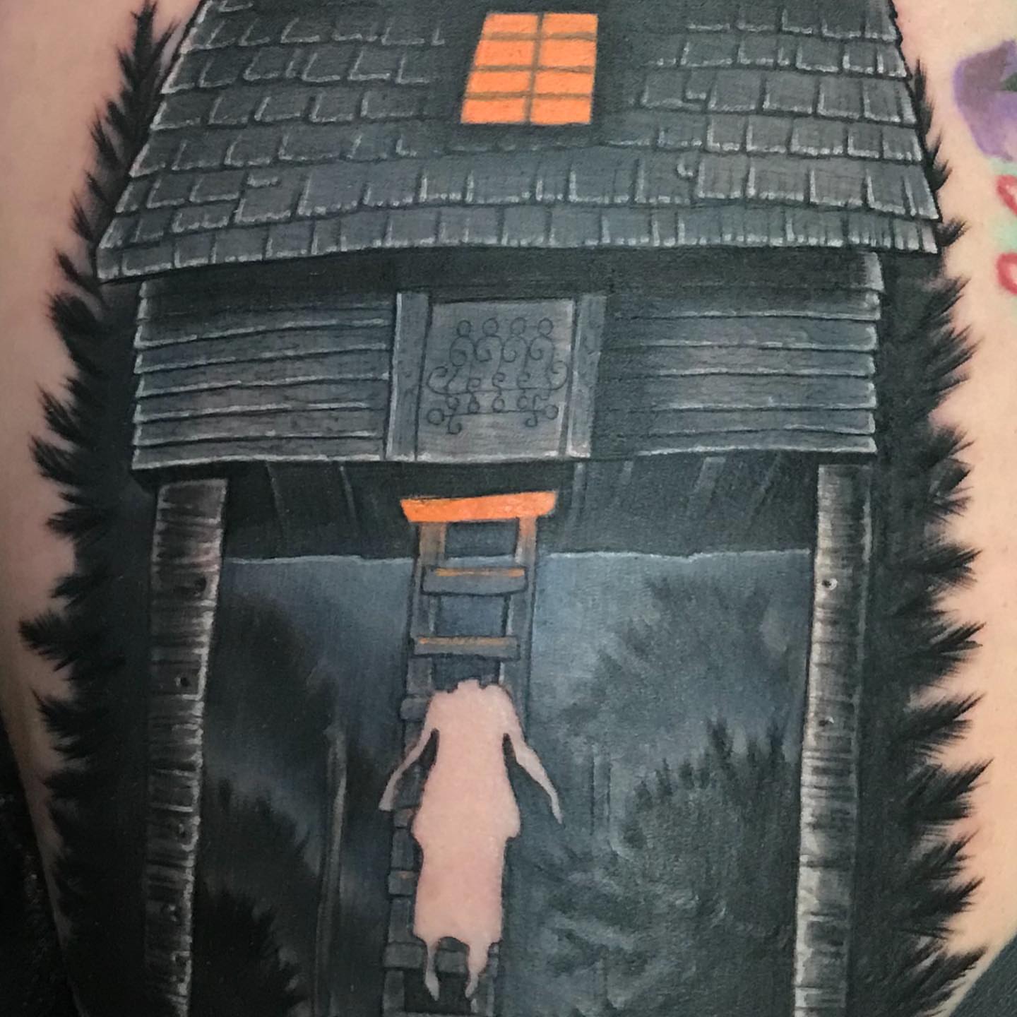 Haunted house dark realism tattoo on the forearm by Rick Rayne