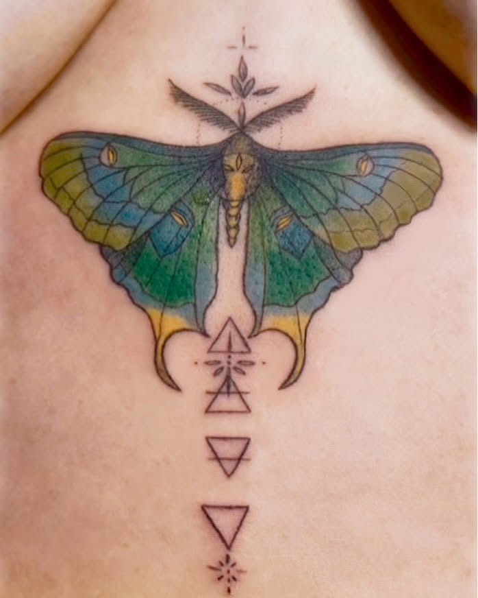 Moth and geometric symbols geometric tattoo on the chest by Healoha “Lindelle” Kamanu