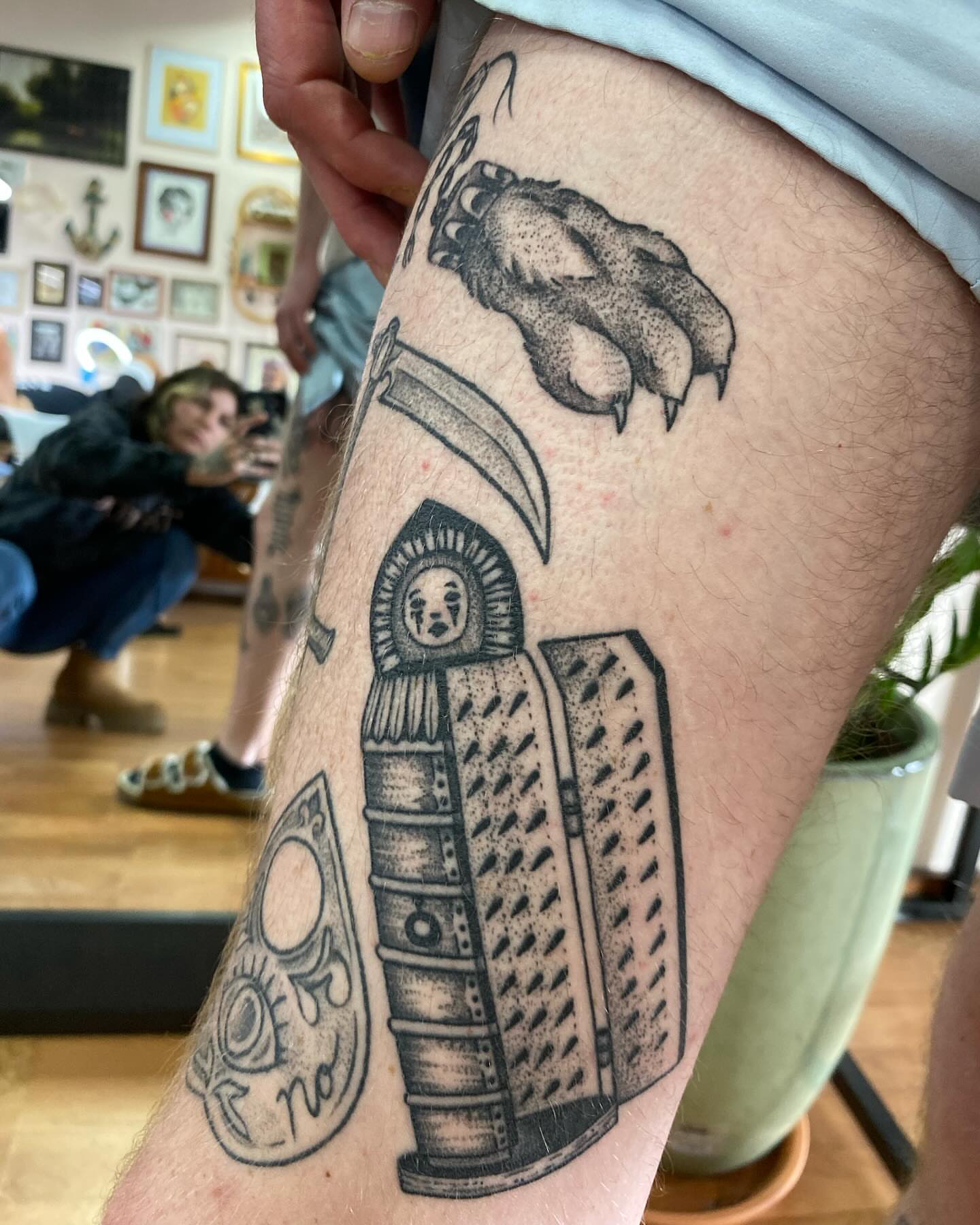 Book with face dotwork tattoo on the thigh by Taya Lynn, Hudson, Wisconsin