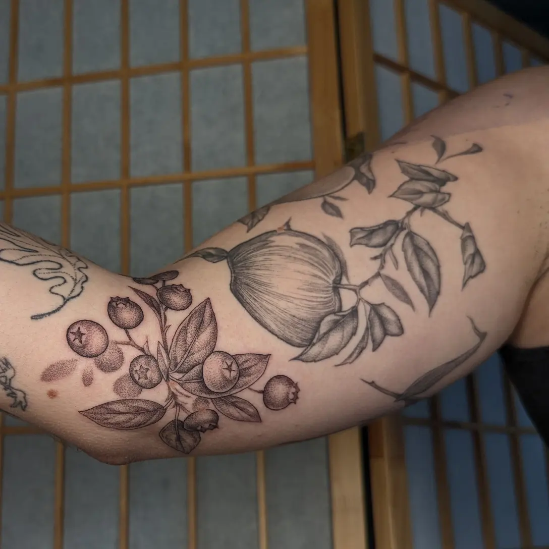 Fruit and berries black and grey tattoo on the forearm by Jeanine, Providence, Rhode Island