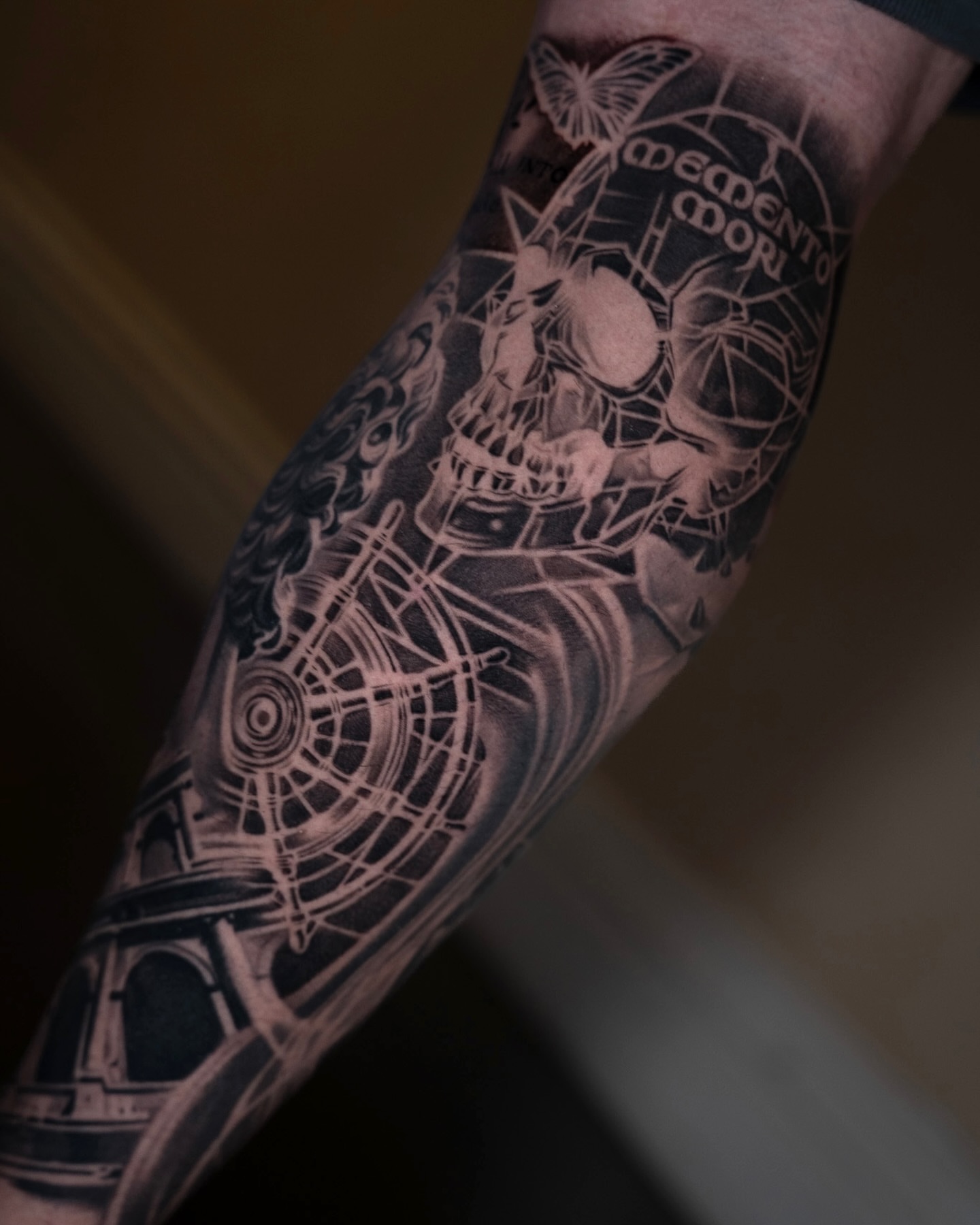 Skull and spider web geometric tattoo on the forearm by Alan Delarosa