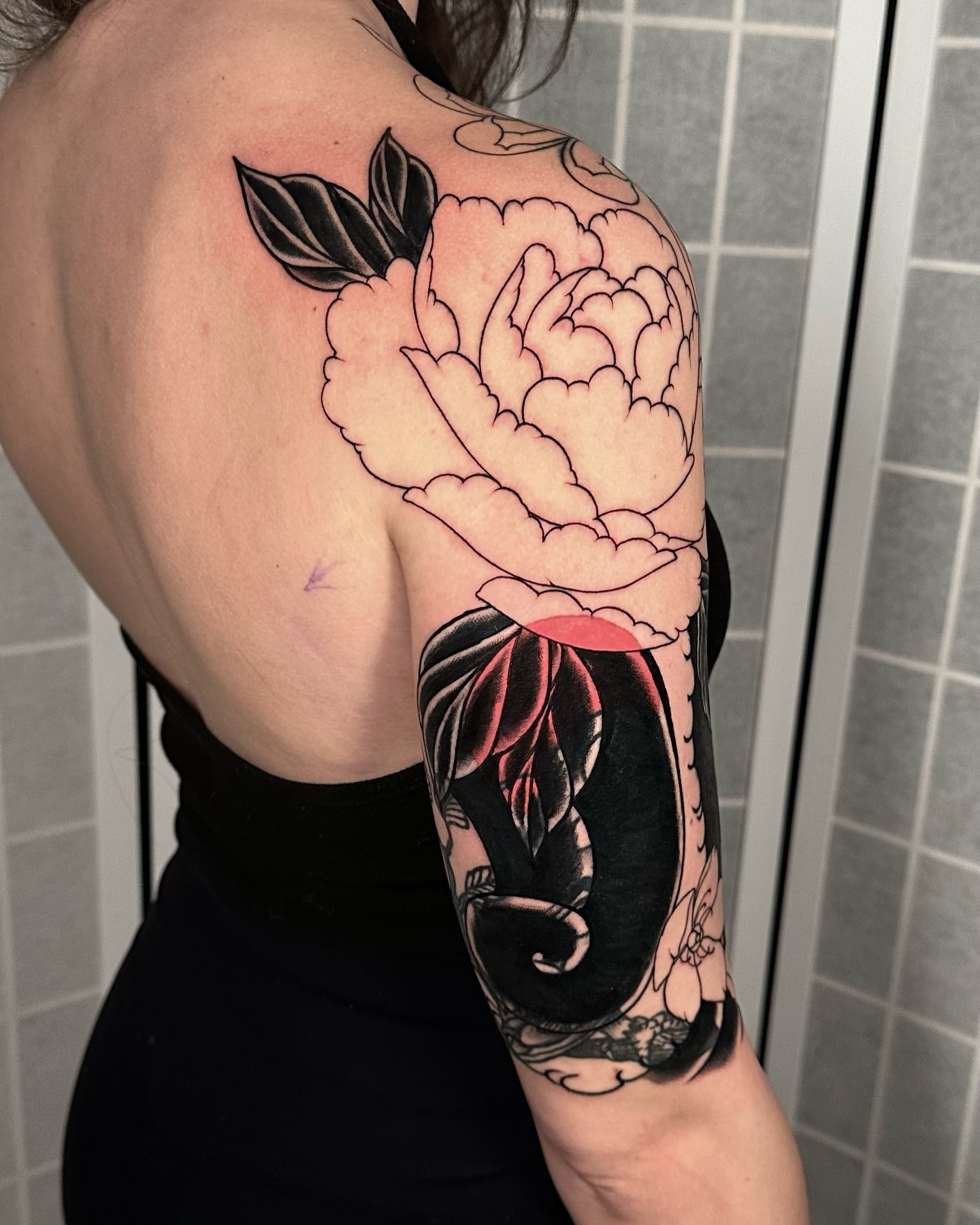 Peony American traditional tattoo on the shoulder by Henry Gaßner
