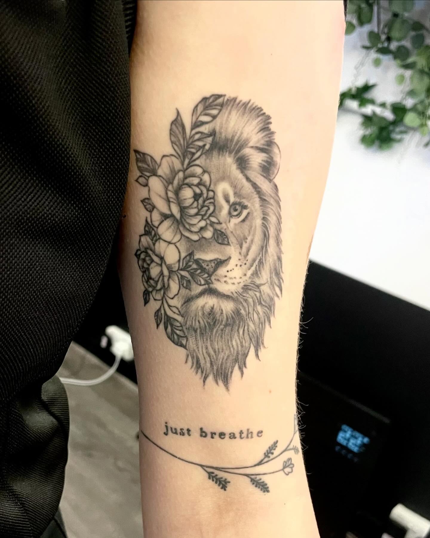 Lion with flowers realism tattoo on the forearm by Grace derby tattooist, Derby