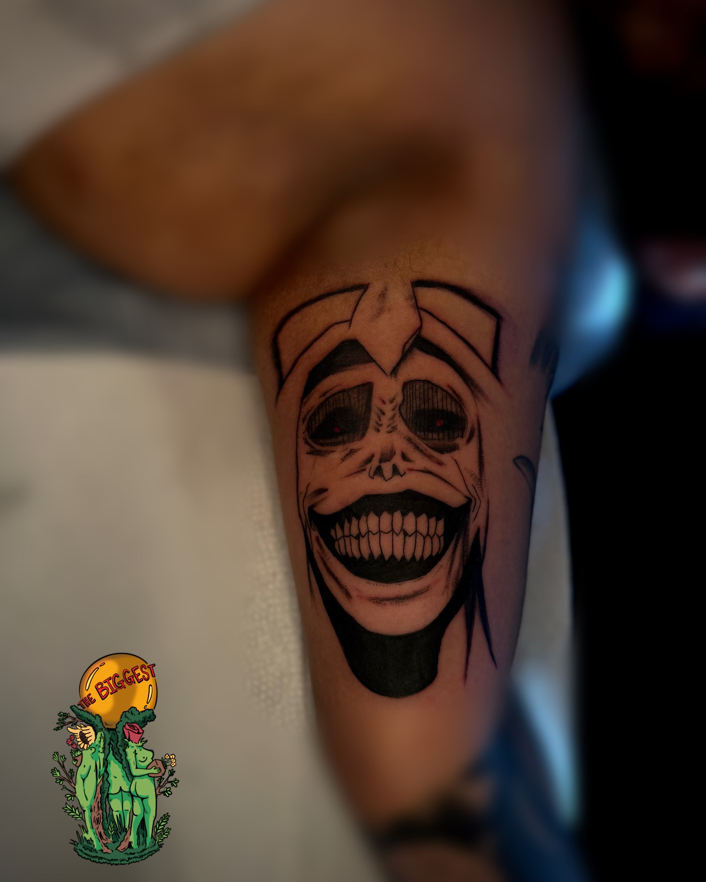 Grinning skull black and grey tattoo on the forearm by Marques Neal