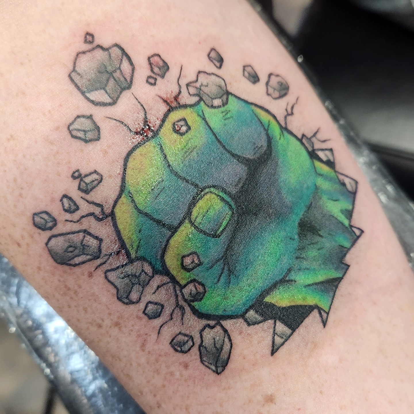 Fist breaking through rock realism tattoo on the forearm by Samantha Von Zombia, Saint Paul, Minnesota