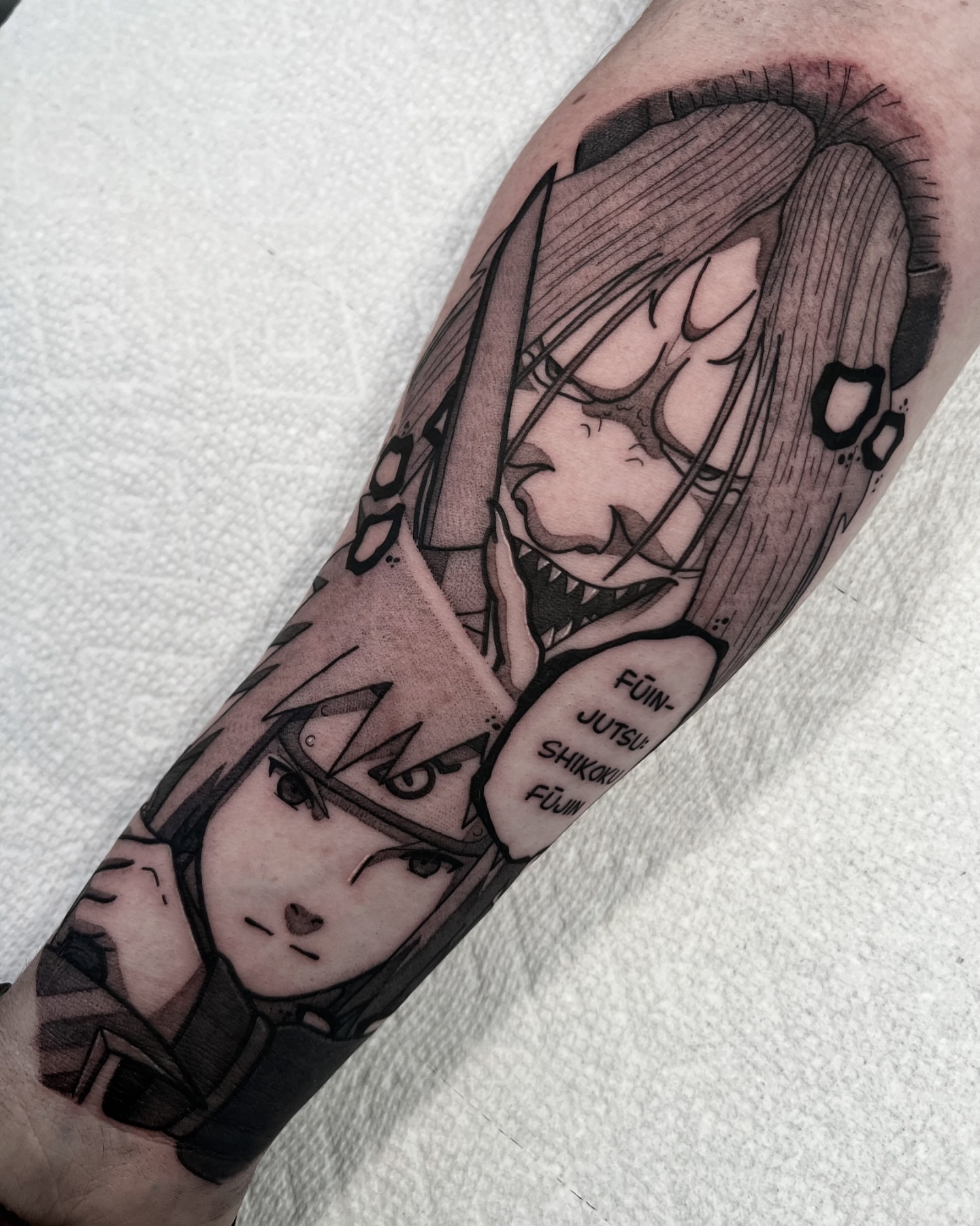 Anime characters anime tattoo on the forearm by Chandler Roe