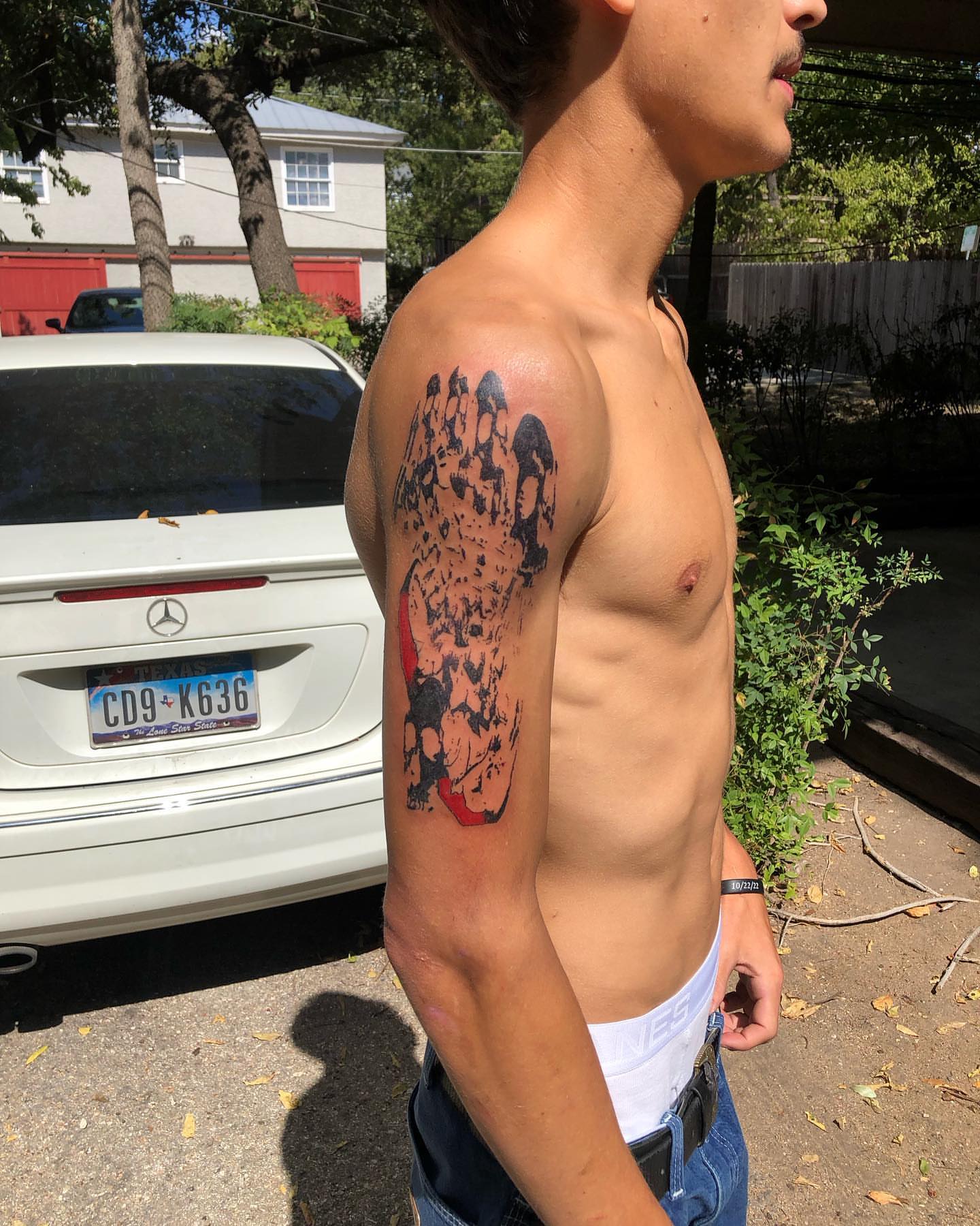 Manga-style characters dotwork tattoo on the upper arm by @emotionalthugtattoo