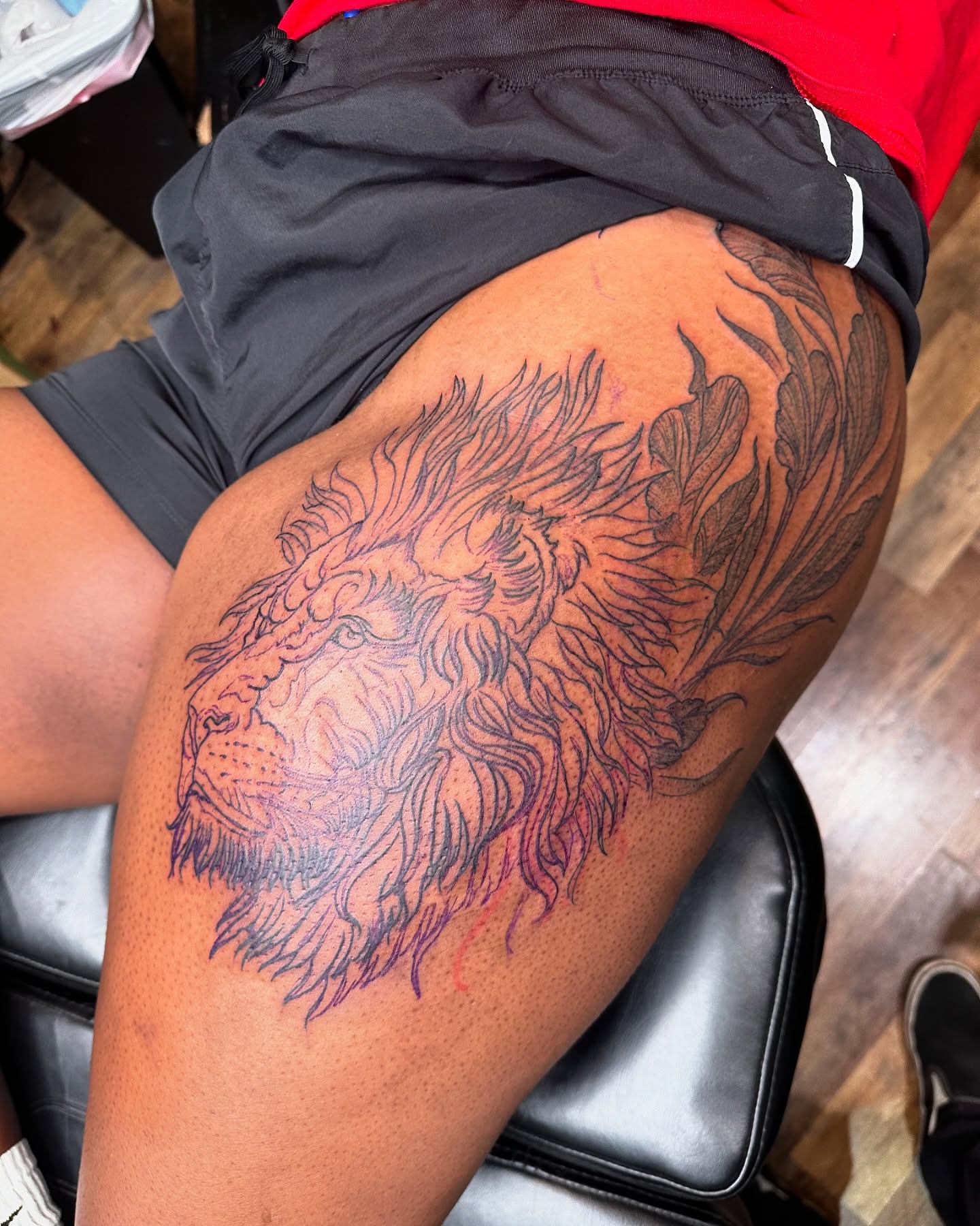 Lion black and grey tattoo on the thigh by Benjamin Carlson