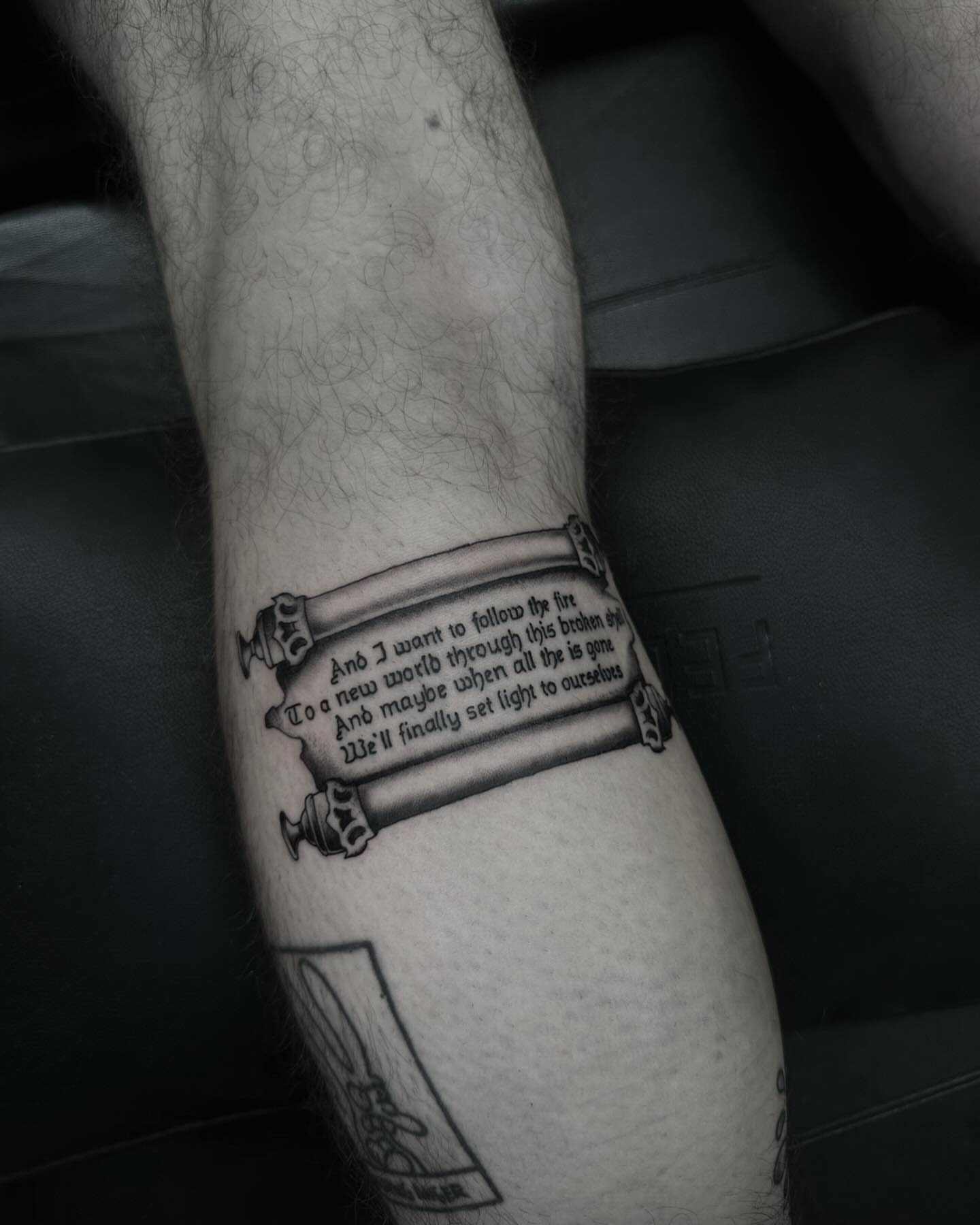 Scroll with text black and grey tattoo on the forearm by ⠀Joey Rosado